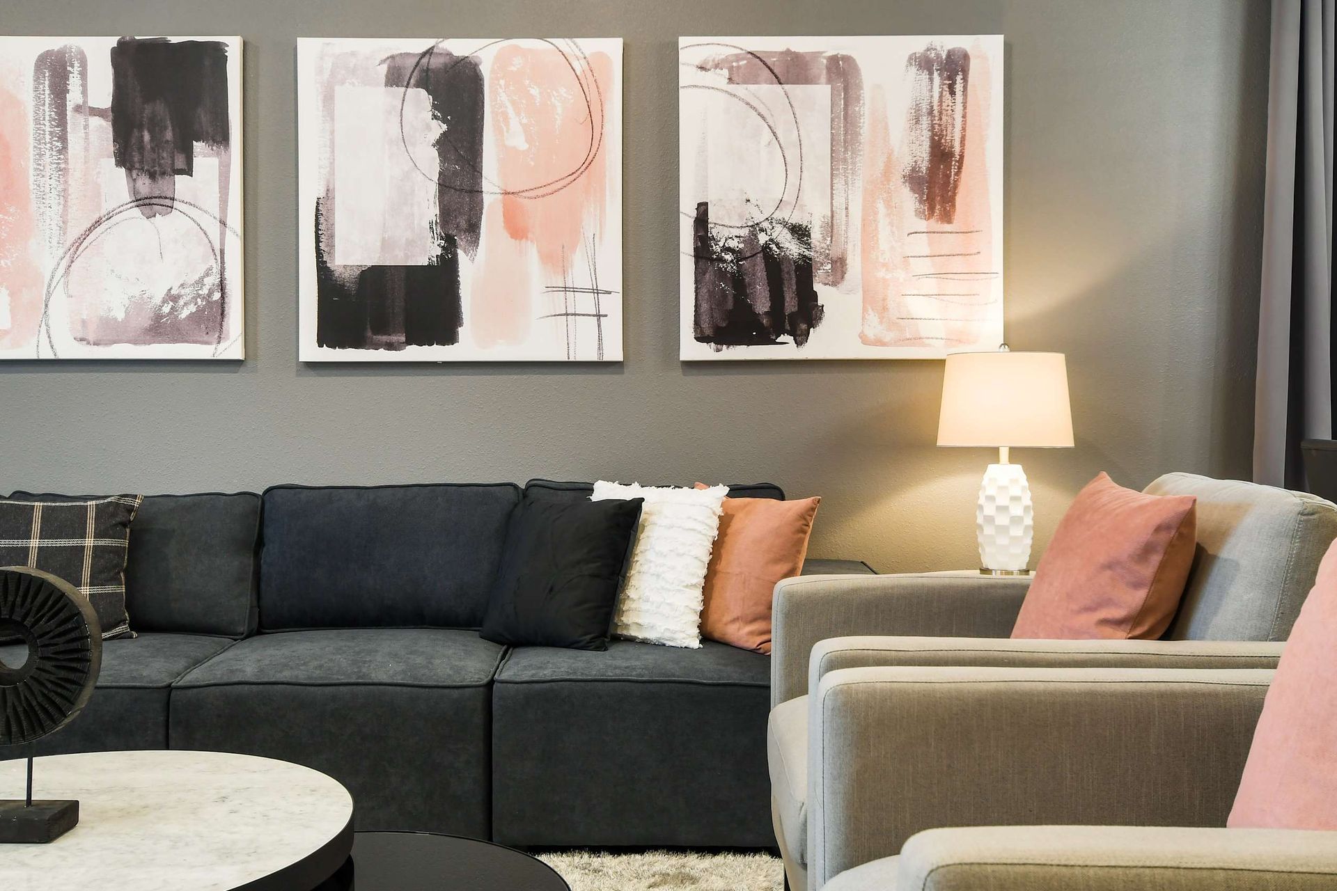 Chic living area with modern art, cozy seating, and a warm, inviting vibe!
