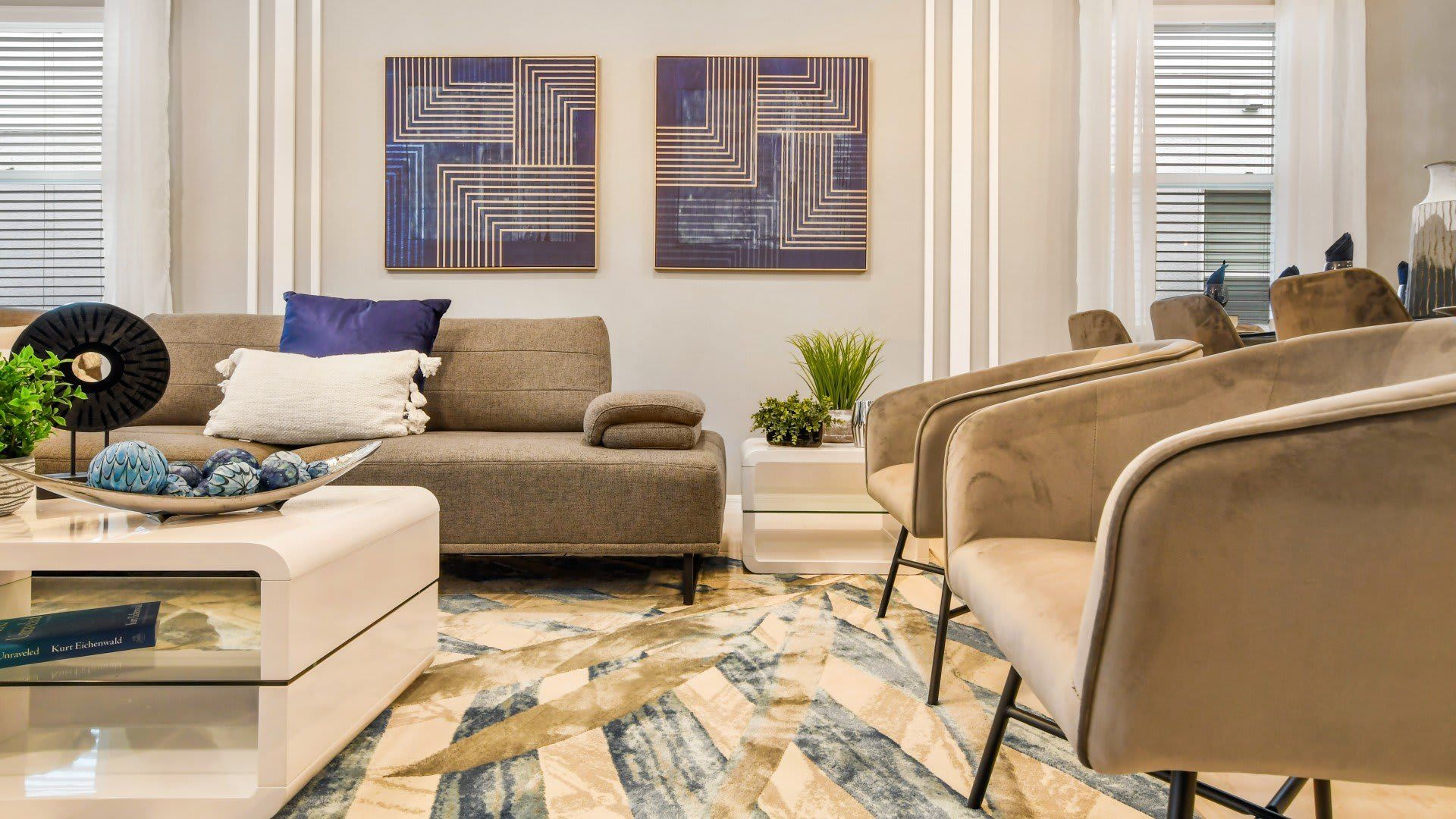 Modern living space with sleek decor, plush seating, and warm neutral tones