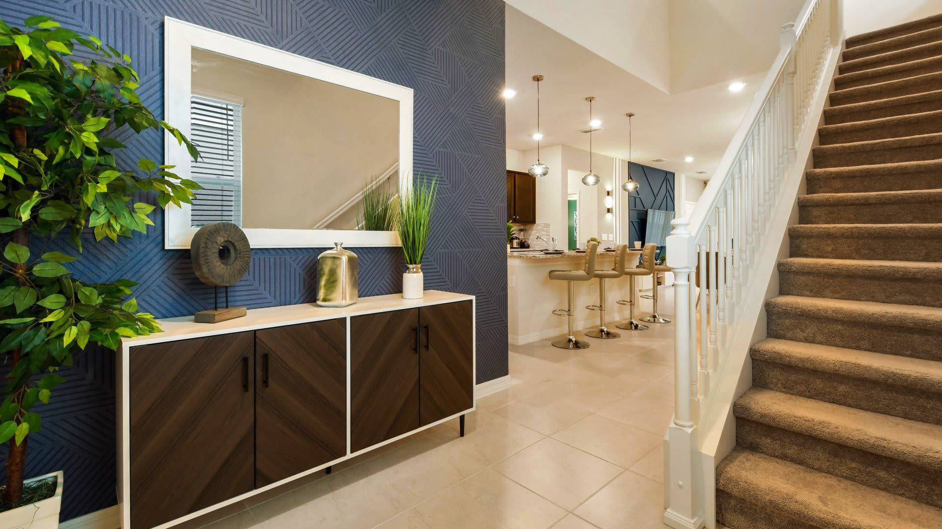 Stylish entryway with modern decor, statement wallpaper, and open-concept layout.