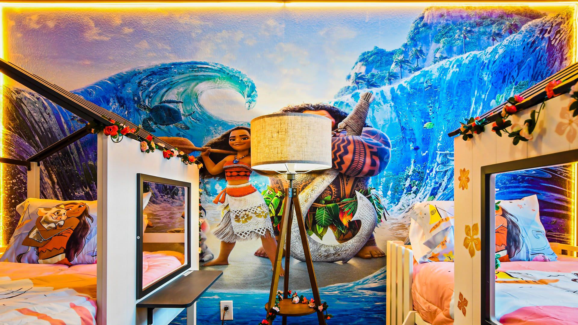 Ocean-themed Moana kids' room with twin beds, murals, and magical island vibes.