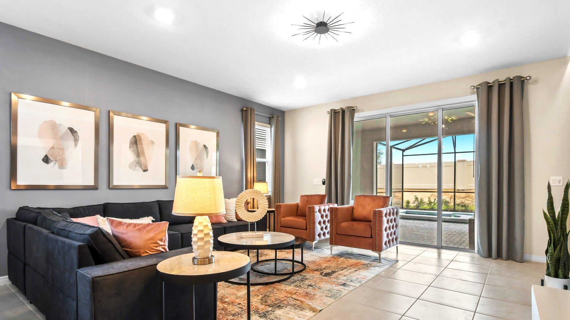 Chic living room with pool view, plush seating, and modern décor.