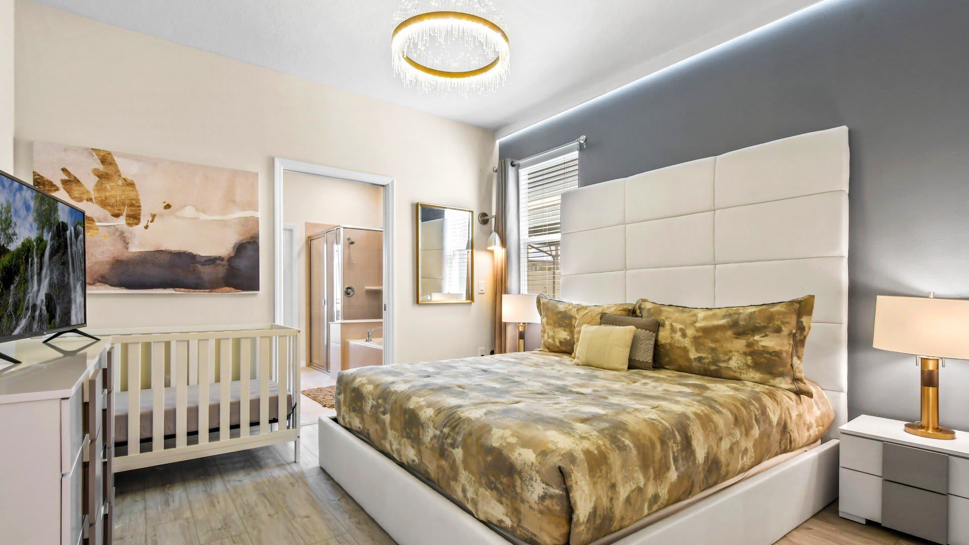 Luxury king suite with ensuite bath, crib, and elegant modern design touches.