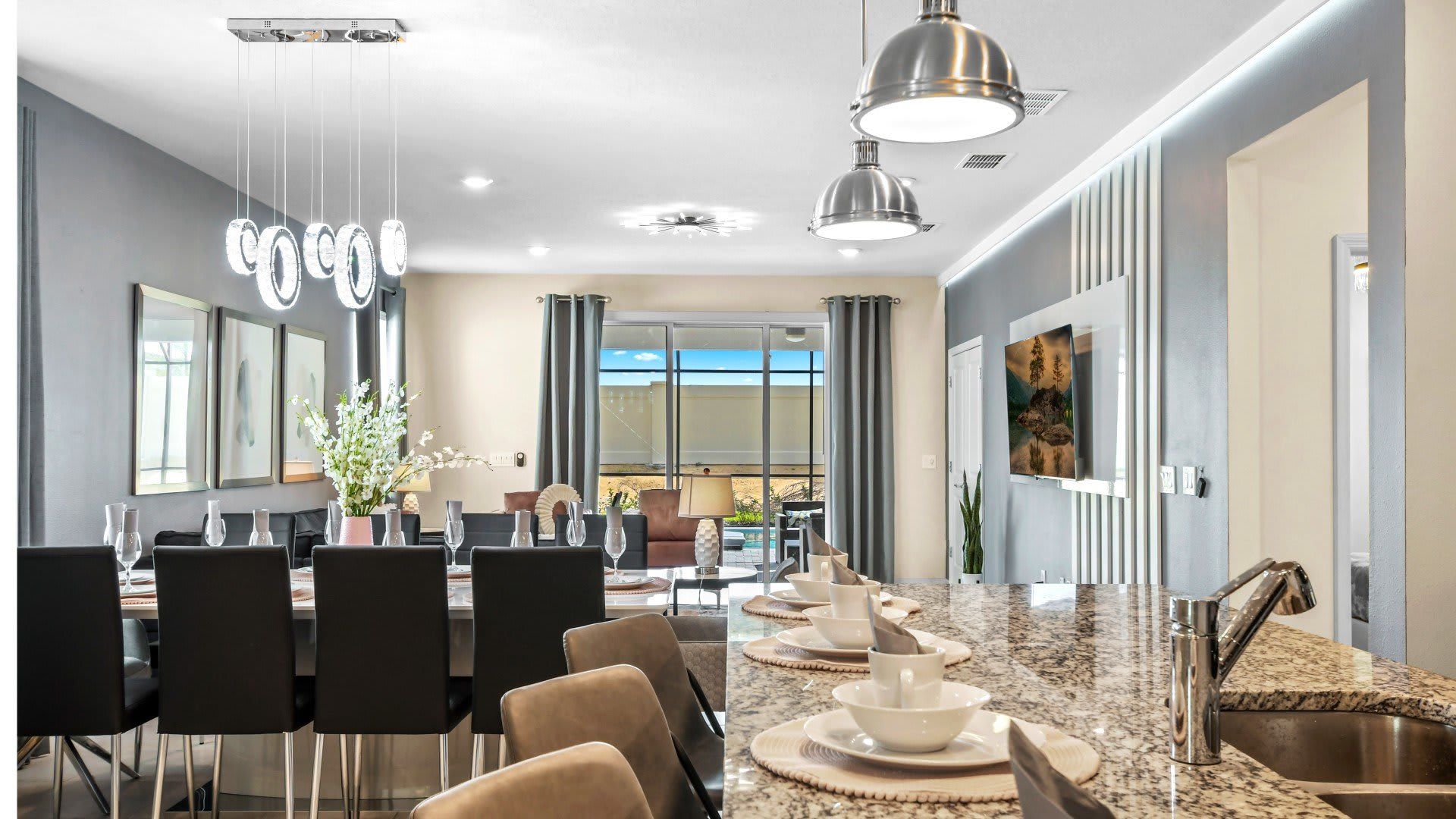 Modern open-concept kitchen and dining with sleek finishes and stylish lighting.