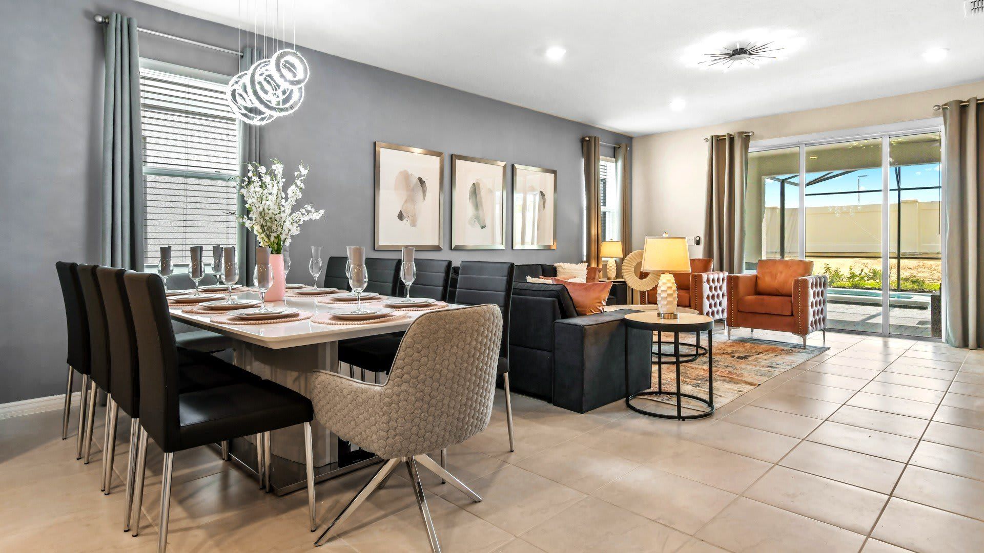 Stylish dining and living space with elegant decor and patio access for relaxation.