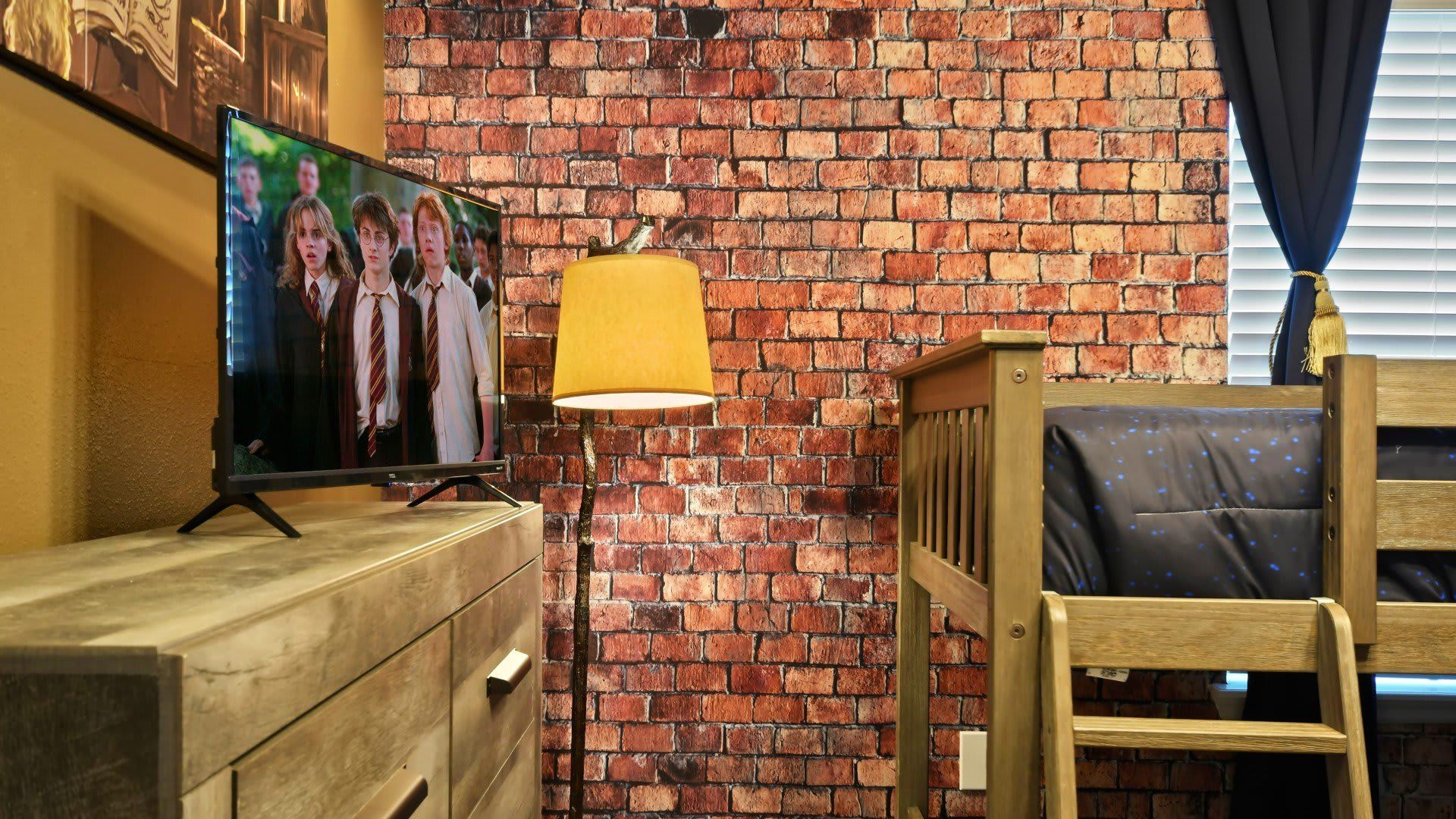 Experience the magic in this Hogwarts-themed room with bunk beds and spellbinding decor.