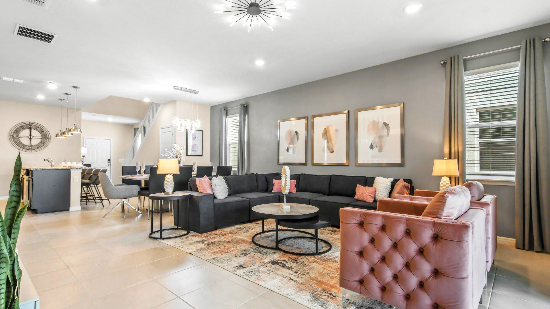 Spacious open-concept living with luxe décor, velvet chairs, and modern flair.