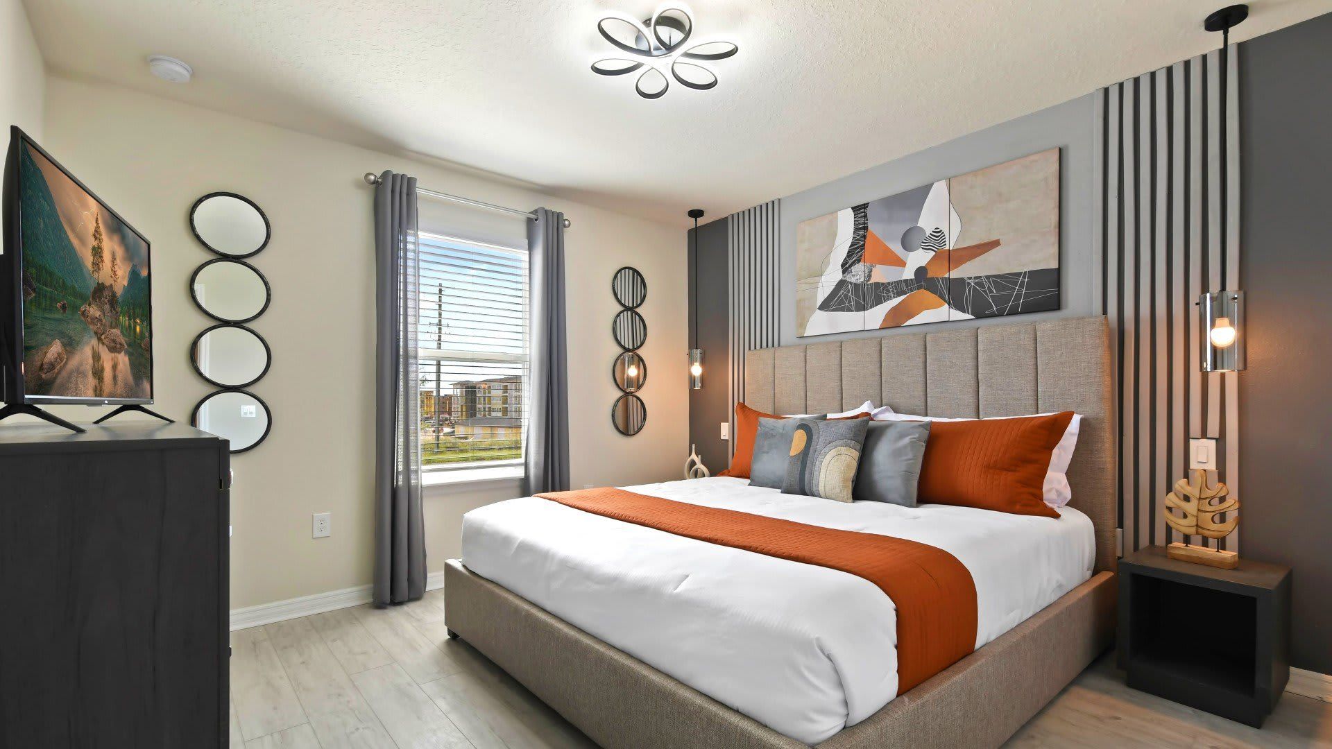 Chic king bedroom with modern decor, warm tones, and natural light-filled space.