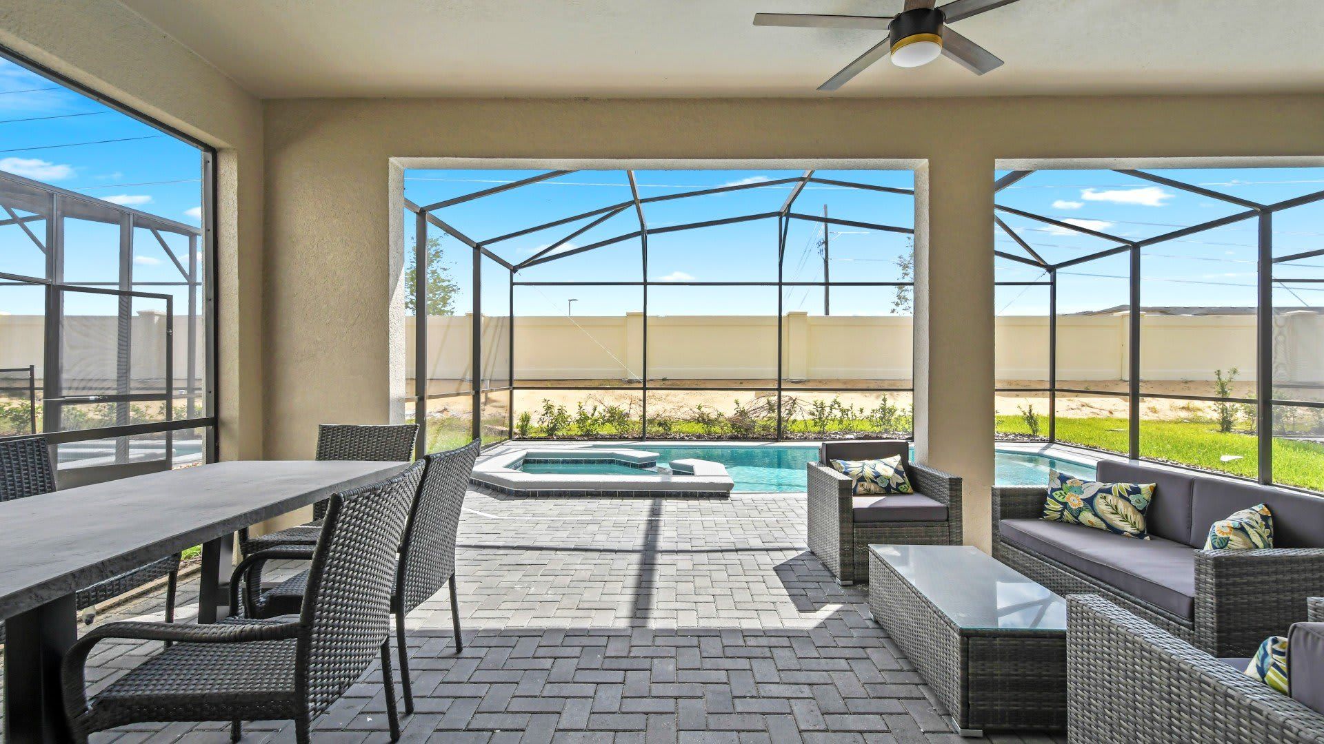Spacious screened patio with dining, lounge seating, and private pool views.