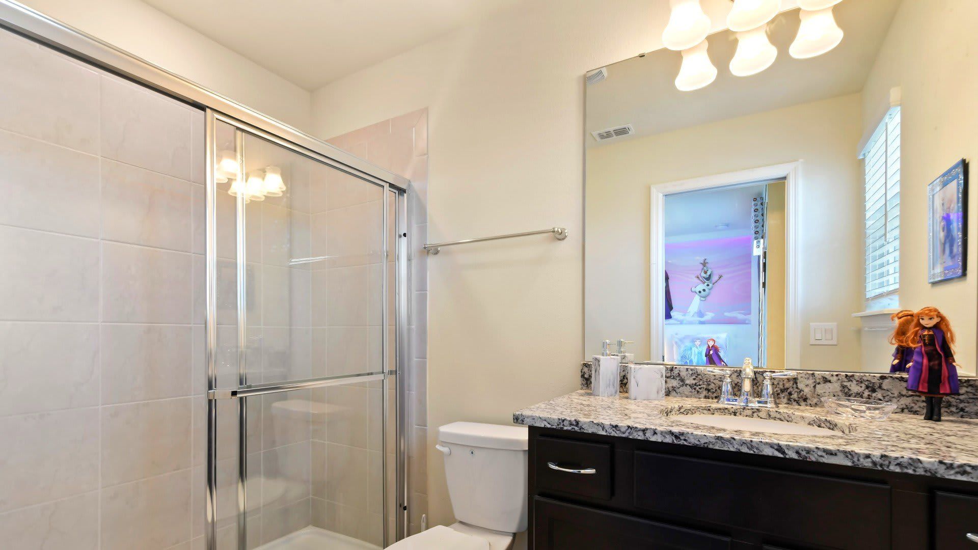 Frozen-themed bathroom with shower, connects to magical twin & full bedroom.
