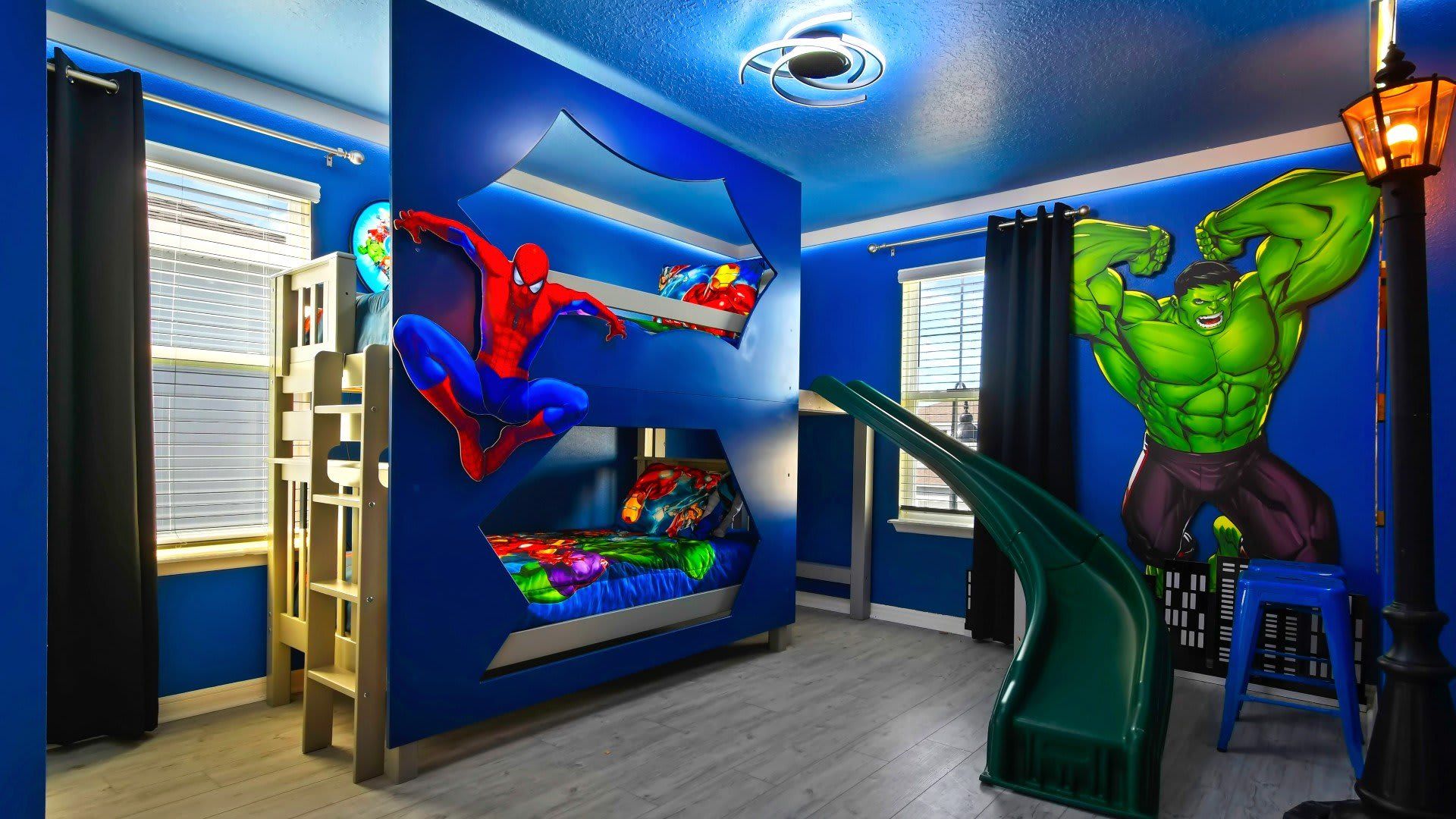 Superhero-themed bunk room with slide—perfect for epic kid adventures!