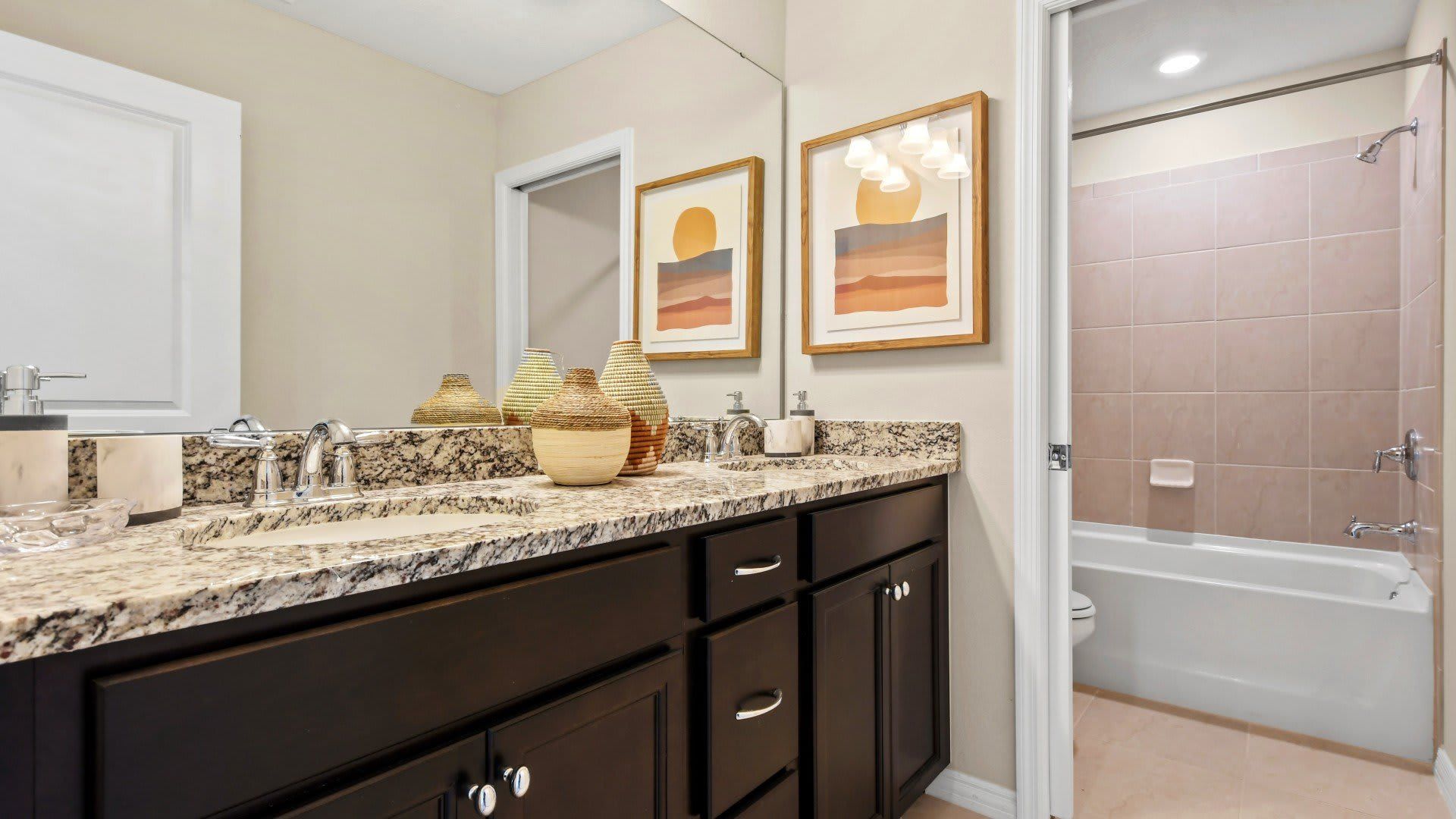 Bright and modern bathroom with granite counters and full-size tub for relaxing soaks.
