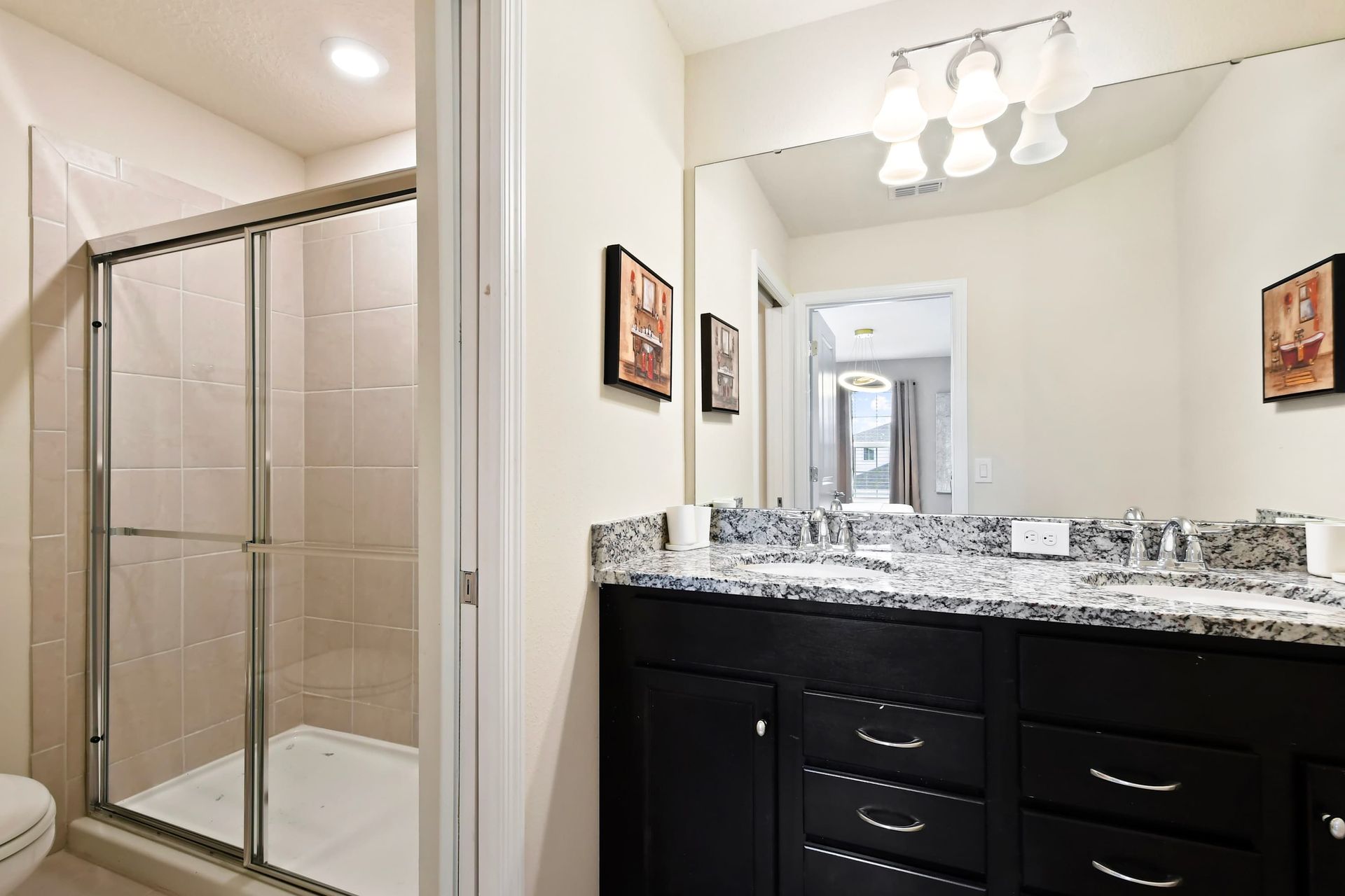 Bright and modern bathroom with dual sinks and a sleek glass walk-in shower.