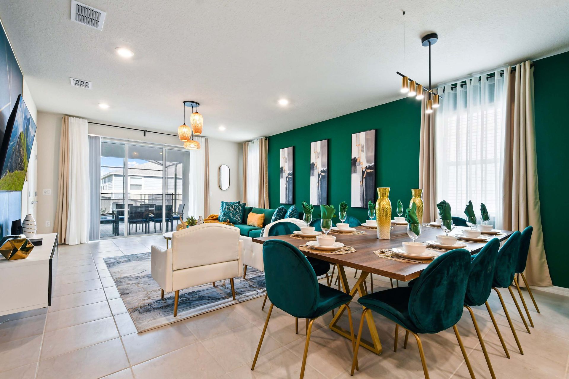Stylish dining and living space with emerald accents and elegant modern design.
