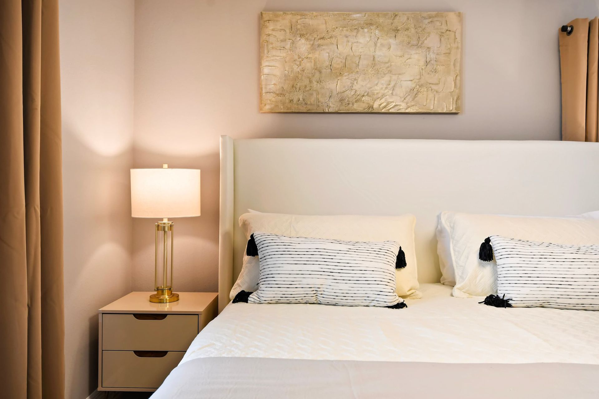 Peaceful king suite with luxe textures, warm lighting, and a calming ambiance.