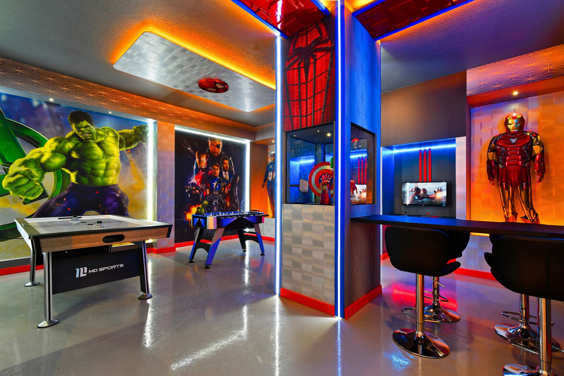 Epic superhero game room with arcade fun, foosball, and vibrant LED lighting.
