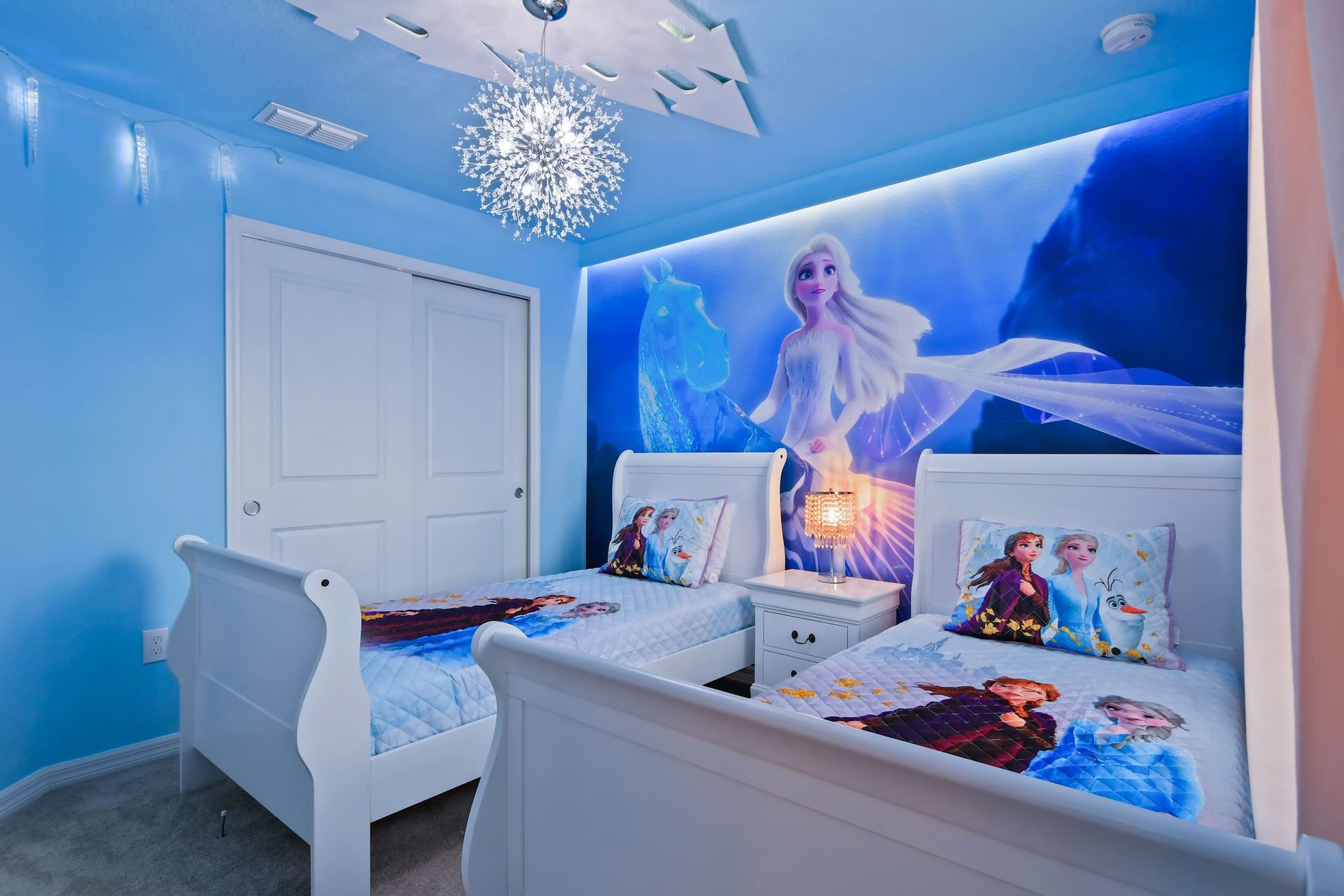 Step into Arendelle in this Frozen-themed twin room with glowing icy details.