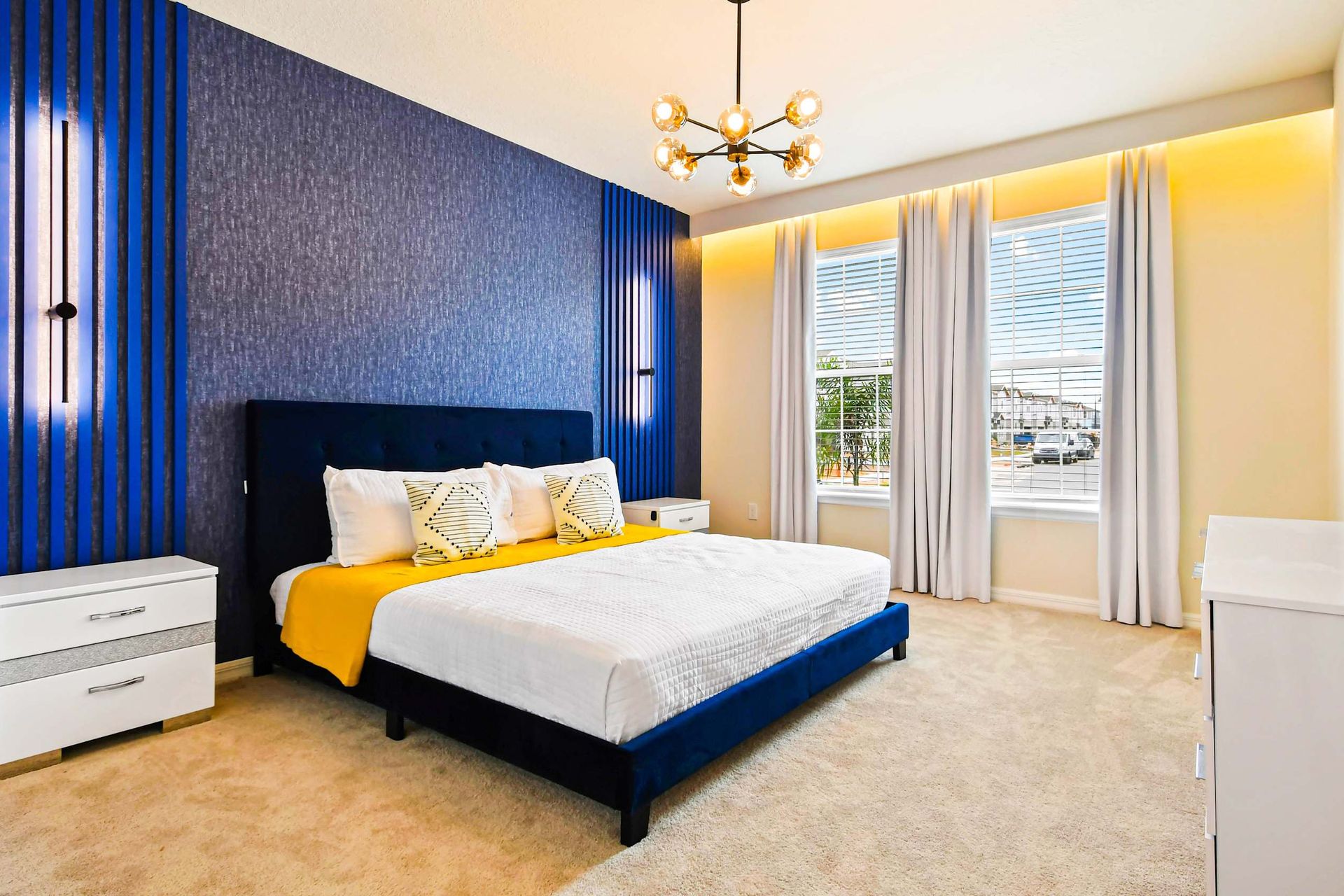 The master bedroom features a luxuriously large king bed with a crib