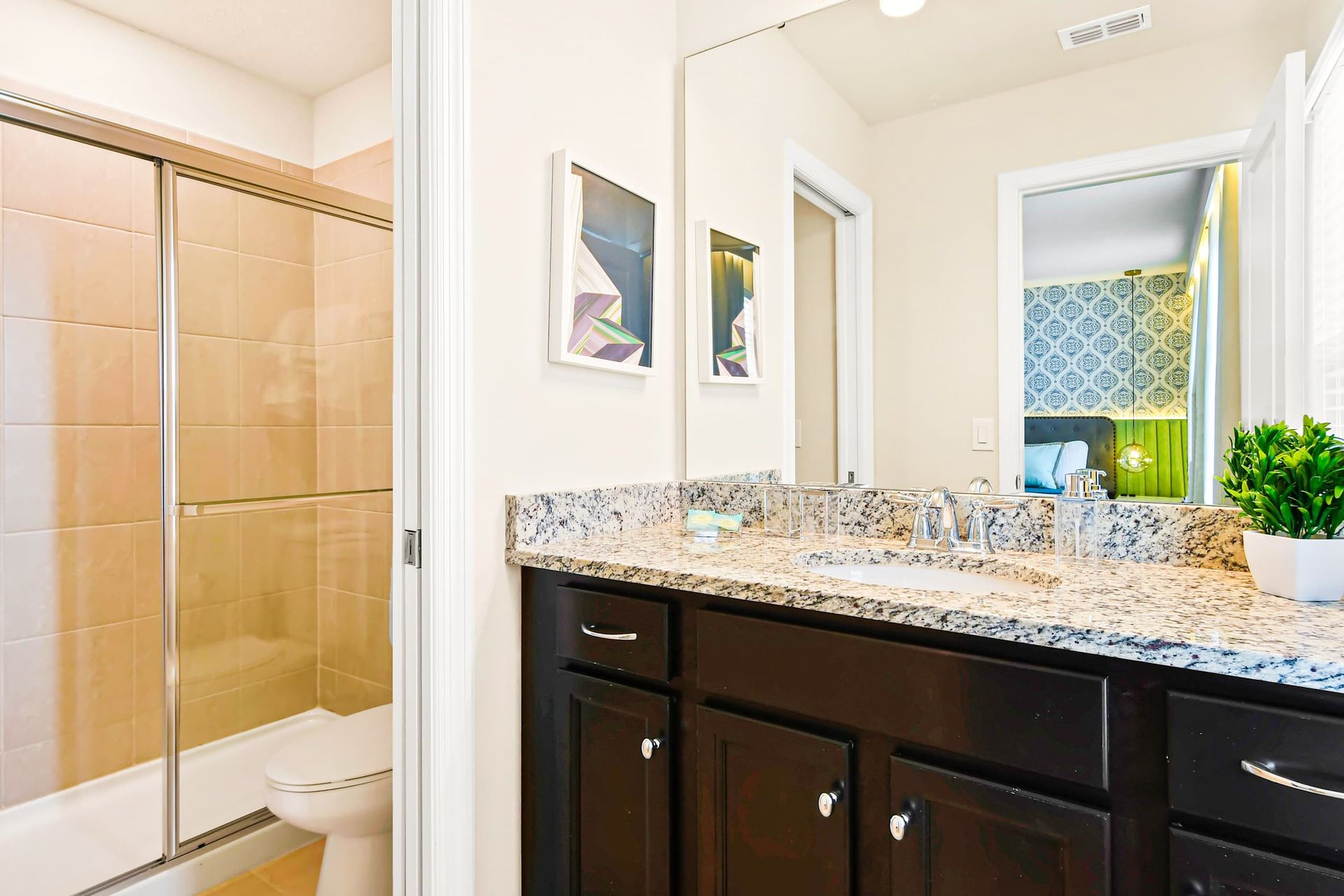 Stylish bathroom with granite double sinks, large shower, and sleek modern design
