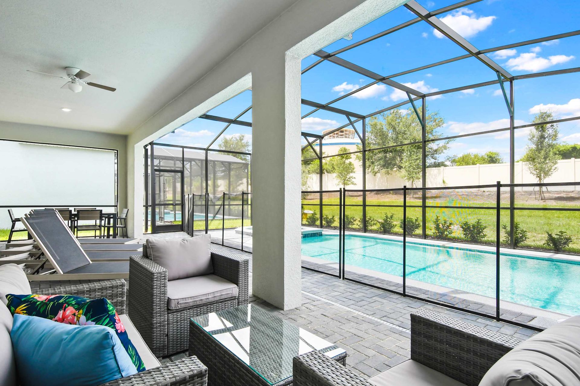 Spacious covered patio with dining area and loungers for ultimate outdoor relaxation
