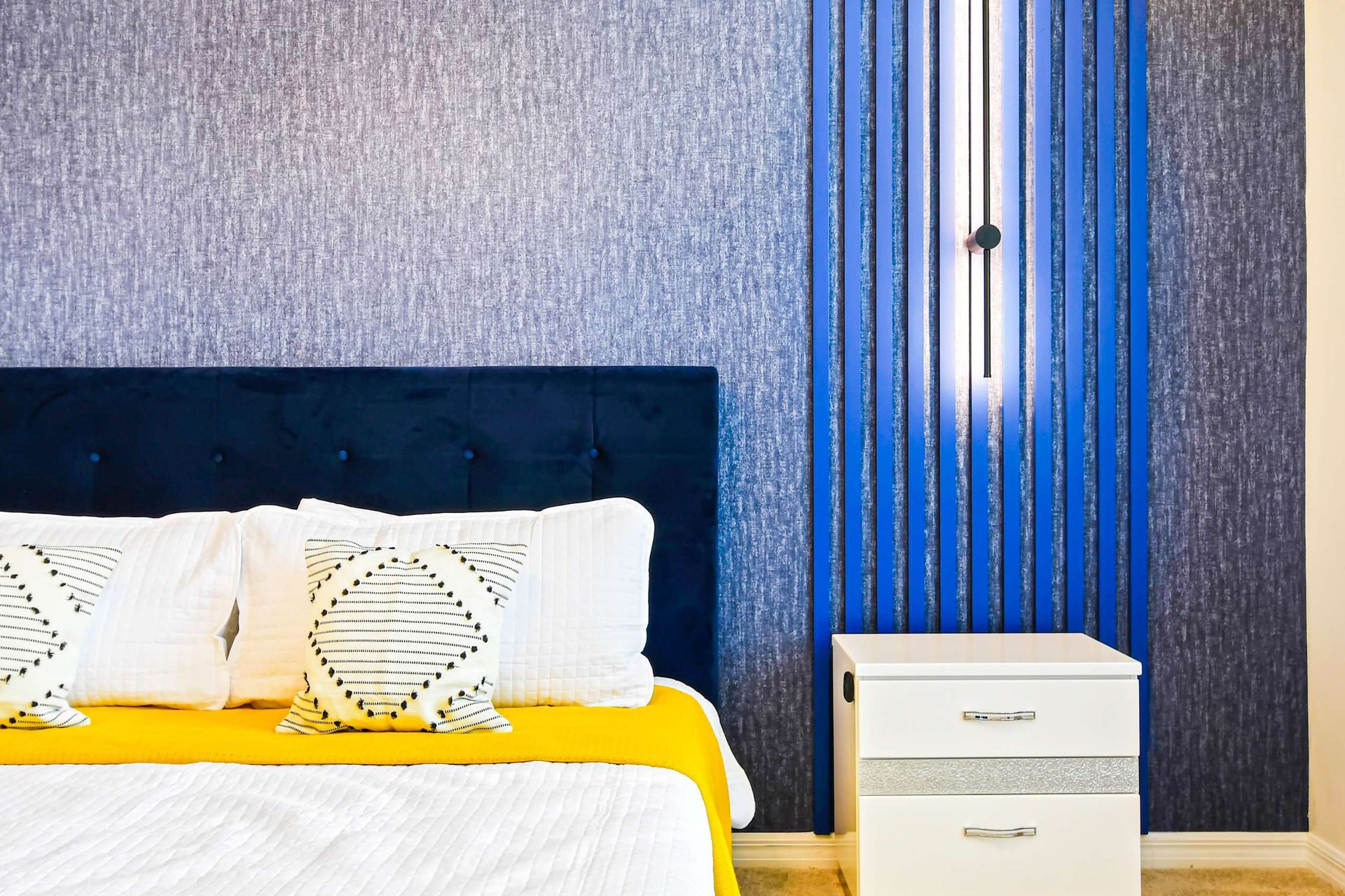 The master bedroom features a luxuriously large king bed with a crib