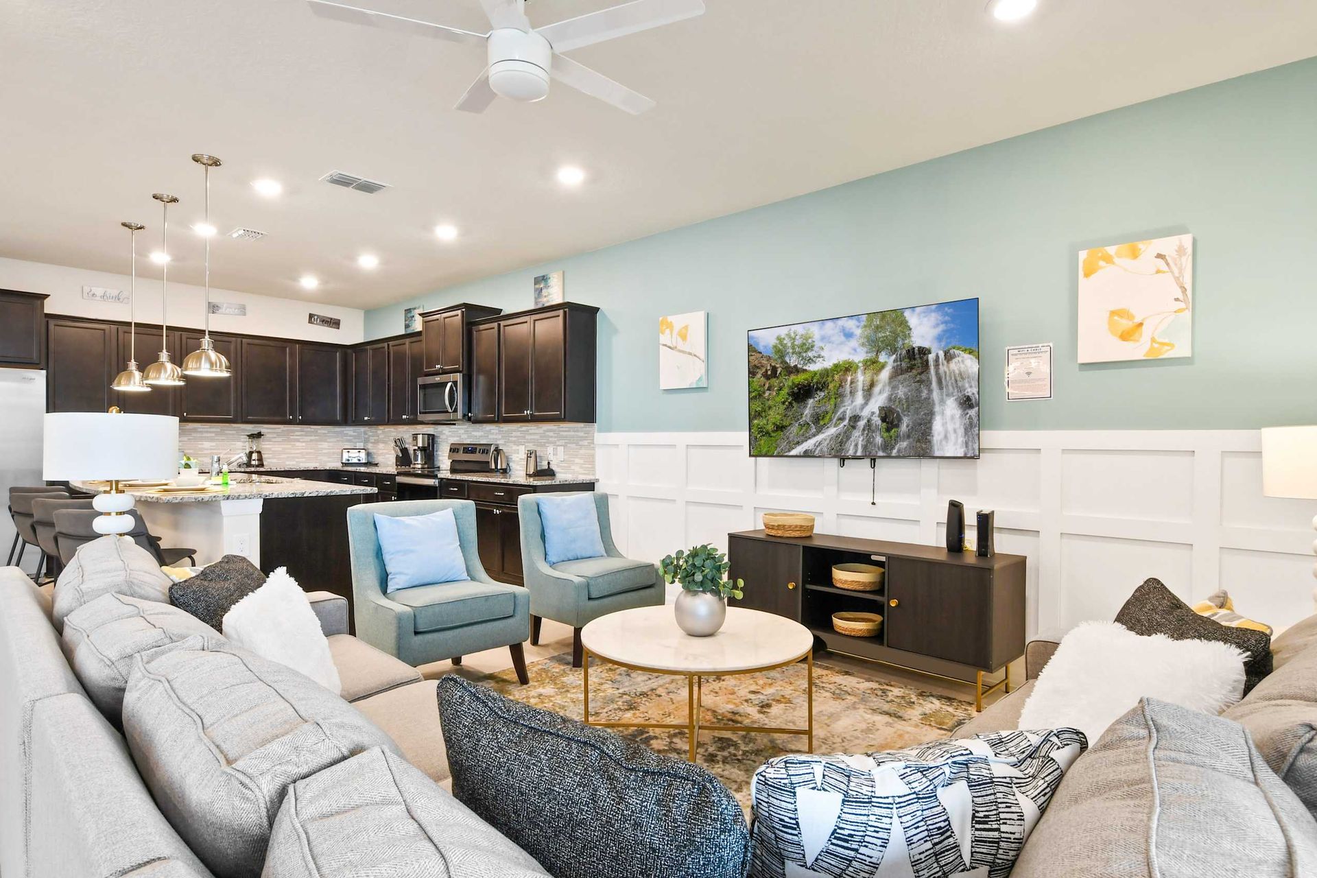 Open-concept living area with a modern kitchen, cozy seating, and stylish decor.