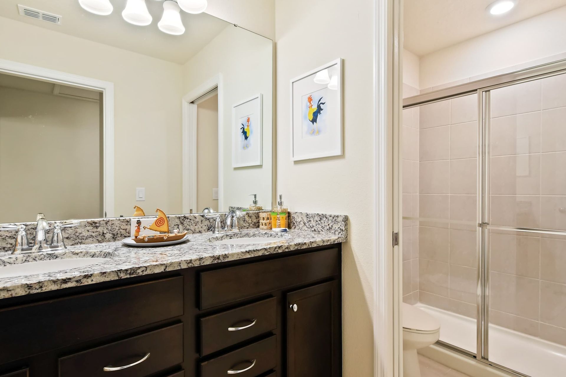 Cheerful bathroom with granite counters, double sinks, and island-inspired accents.