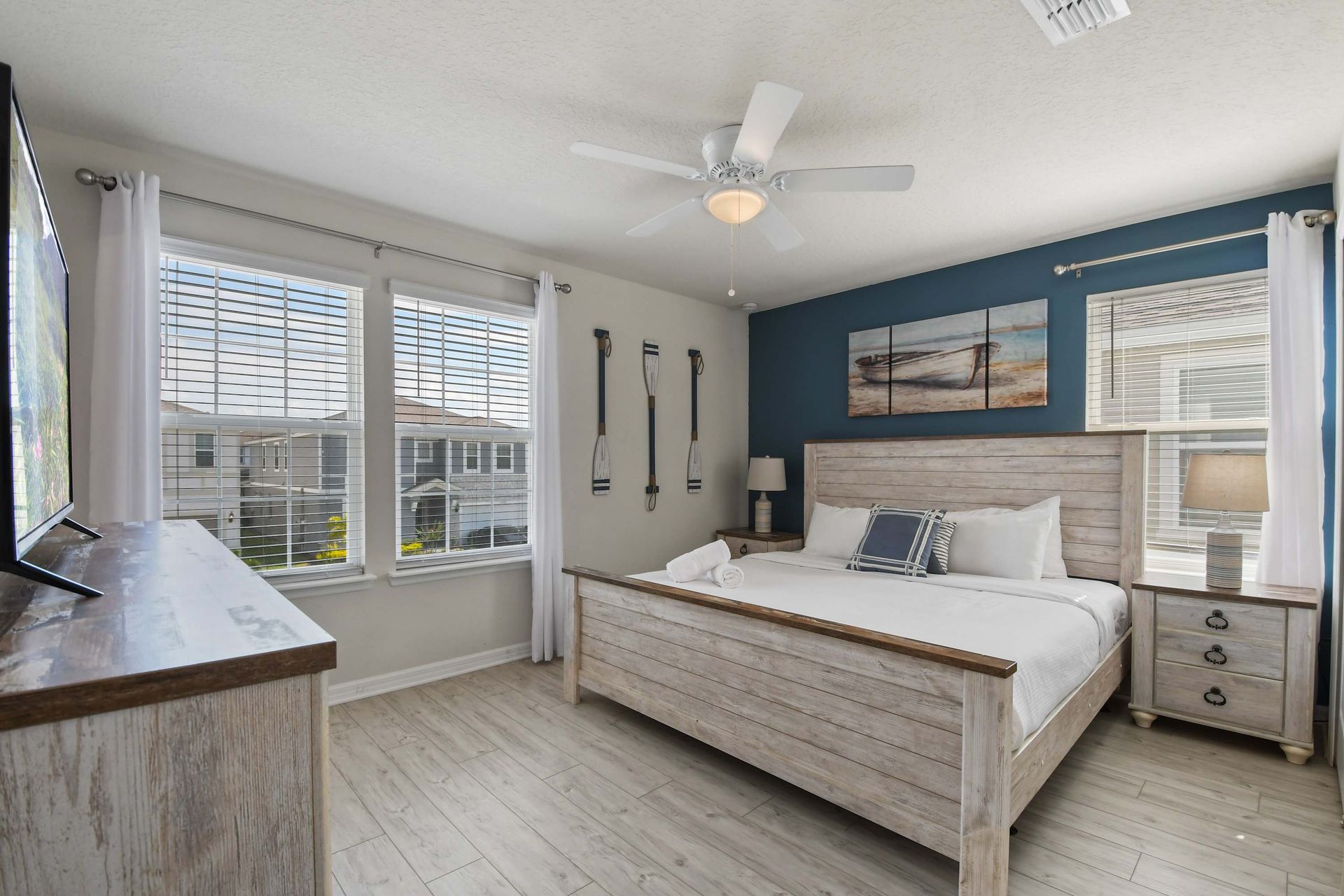 Coastal-themed bedroom with rustic wood decor, natural light, and serene vibes.