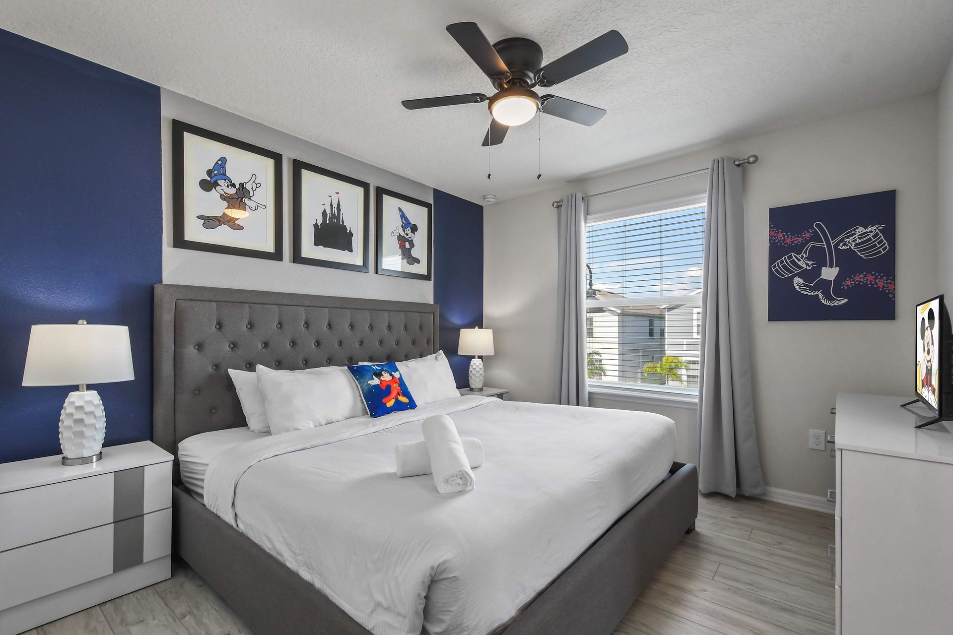 Whimsical bedroom with magical decor, plush king bed, and bright natural light.