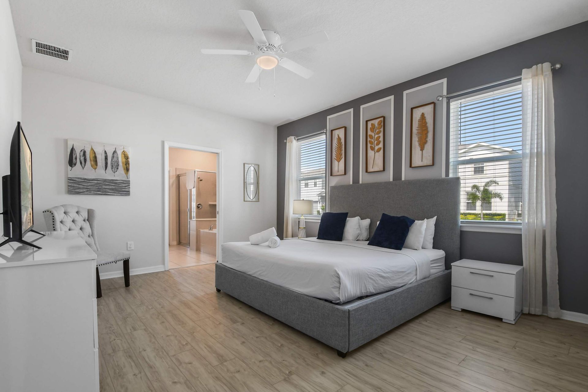 Spacious master suite with elegant decor, natural light, and a private bathroom.