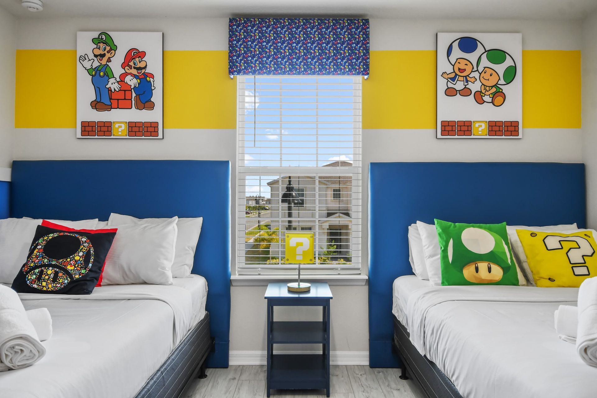 Colorful gaming-themed room with twin beds, playful decor, and bright accents.