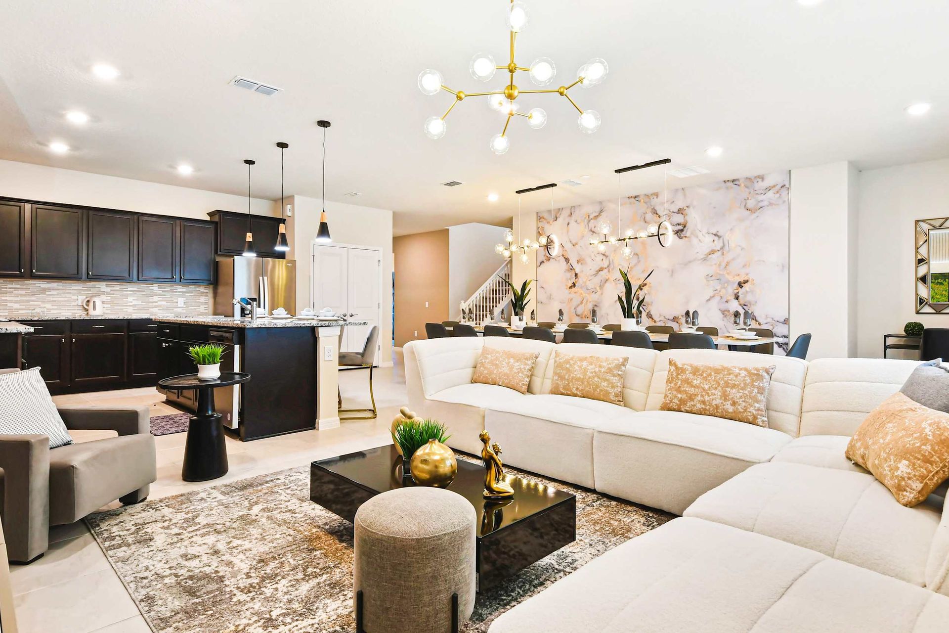 Spacious open-concept living with modern decor and elegant dining area.
