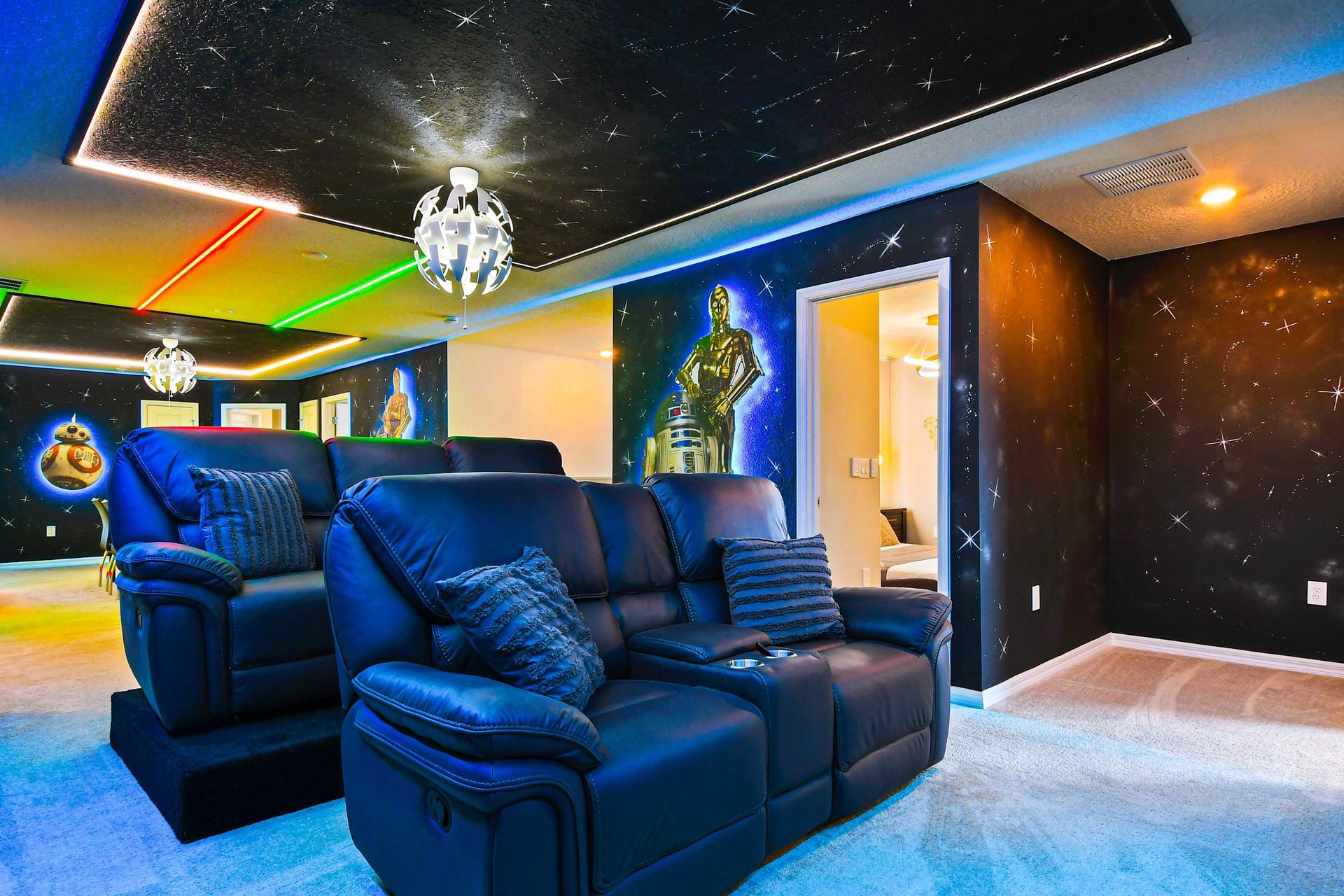 Epic Star Wars-themed theater with recliners, galaxy murals, and neon lighting.