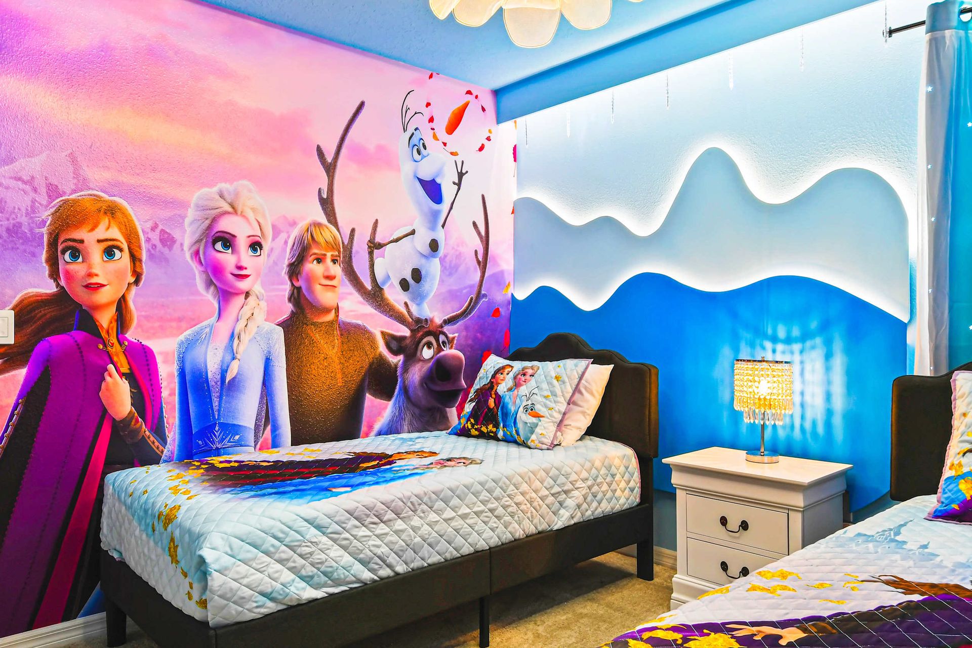 Enchanting Frozen-themed room with icy decor, cozy beds, and twinkling lights.
