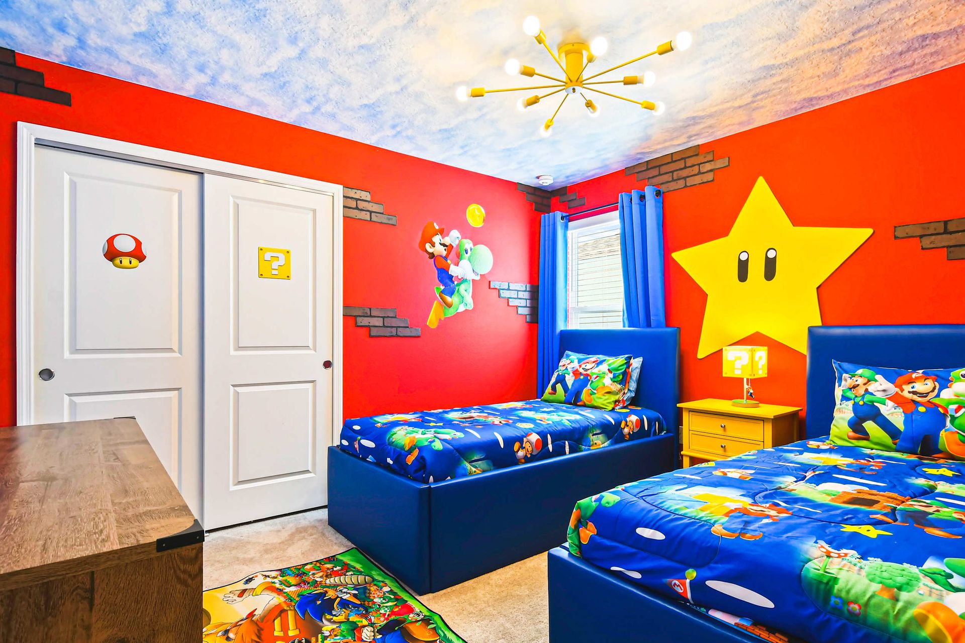 Vibrant Mario-themed room with colorful murals, cozy beds, and fun decor.