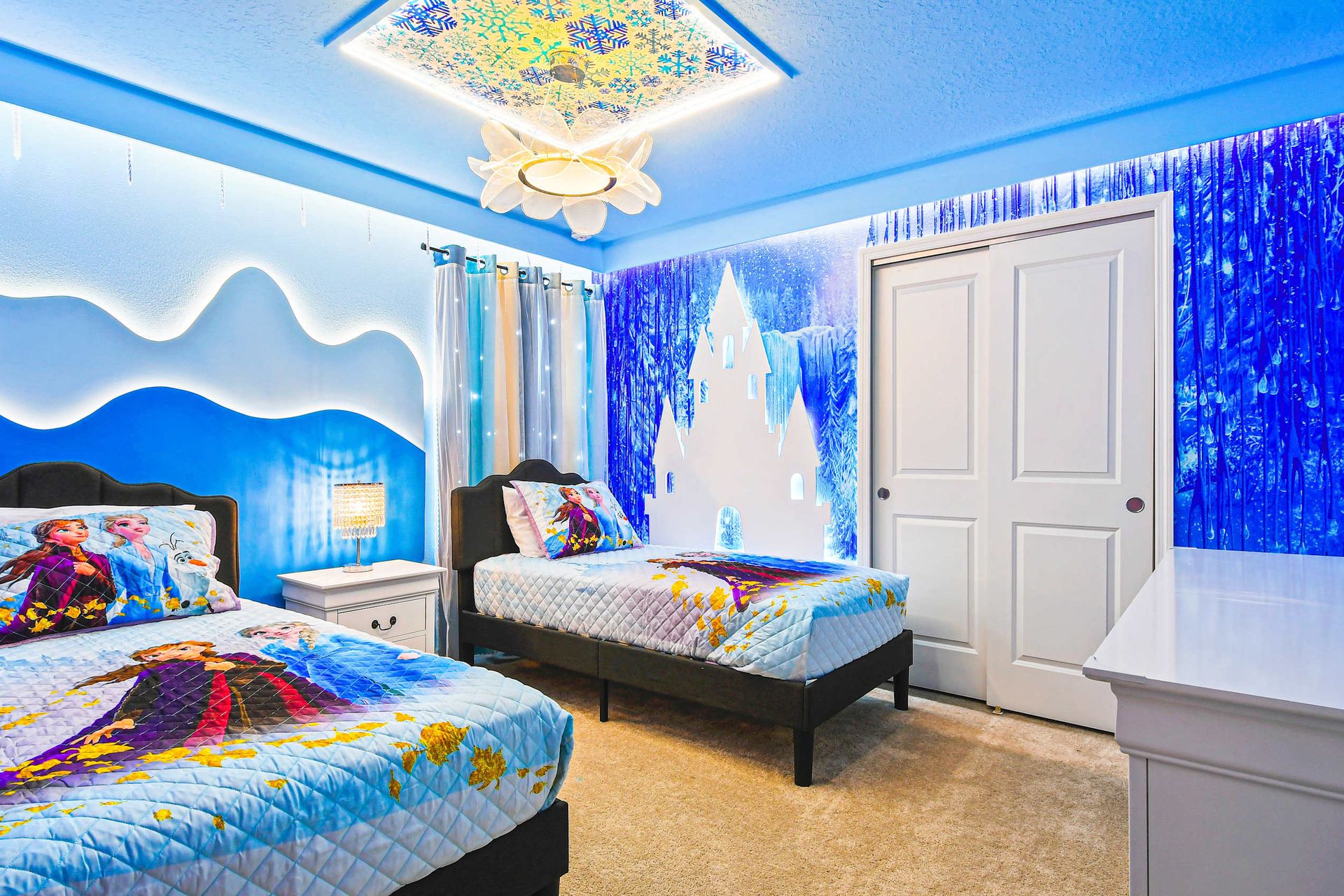 Enchanting Frozen-themed room with icy decor, cozy beds, and twinkling lights.