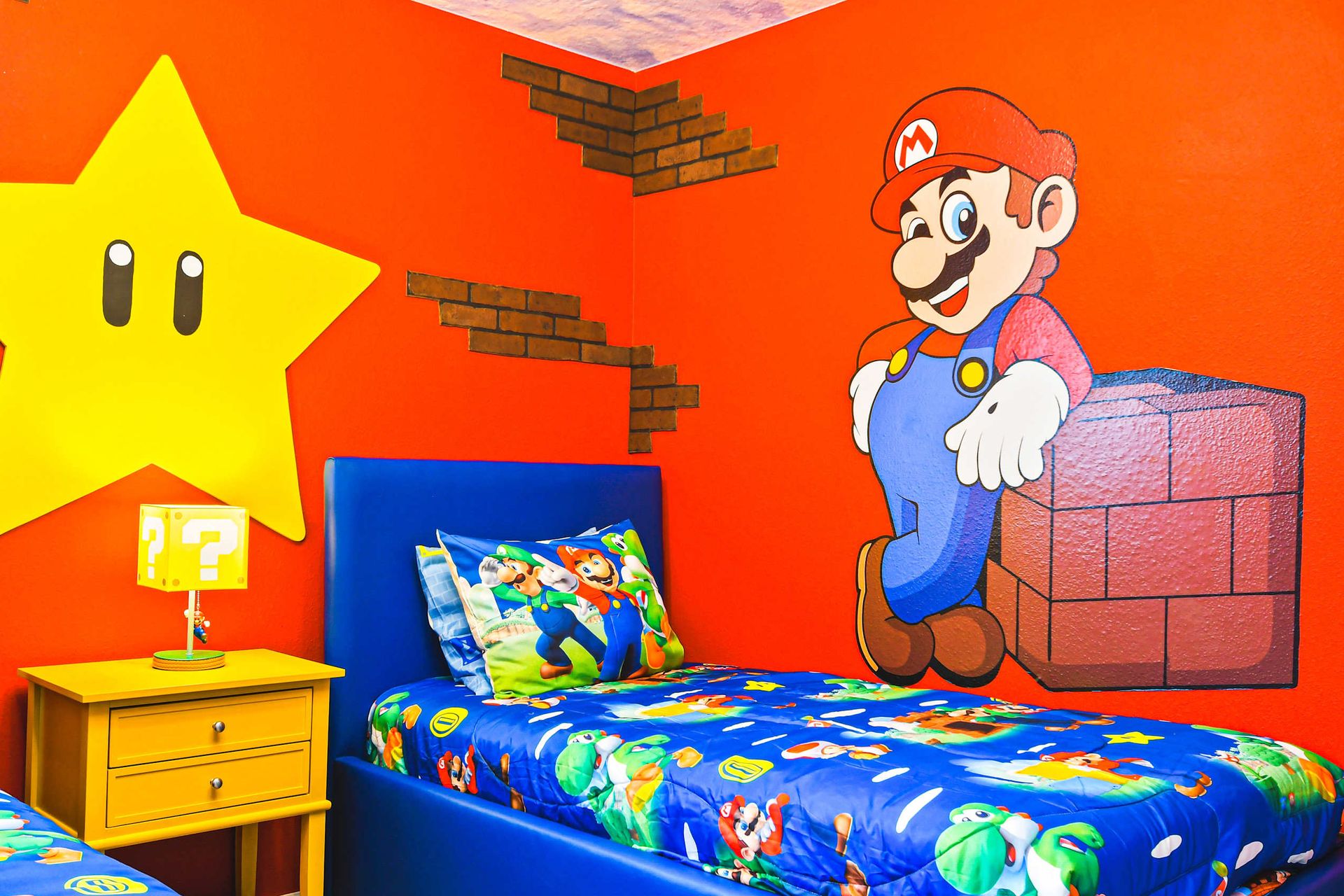 Vibrant Mario-themed room with colorful murals, cozy beds, and fun decor.