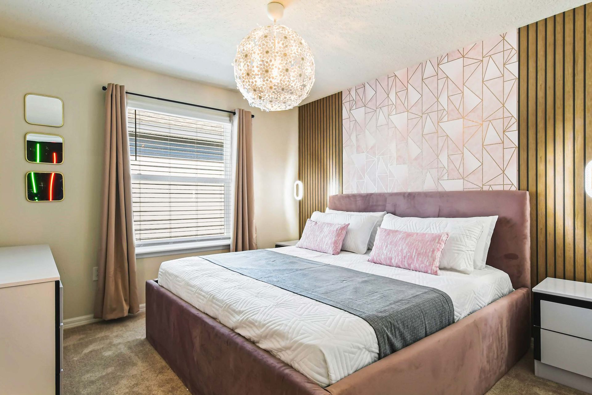 Chic bedroom with geometric accents, soft lighting, and plush velvet bedding.