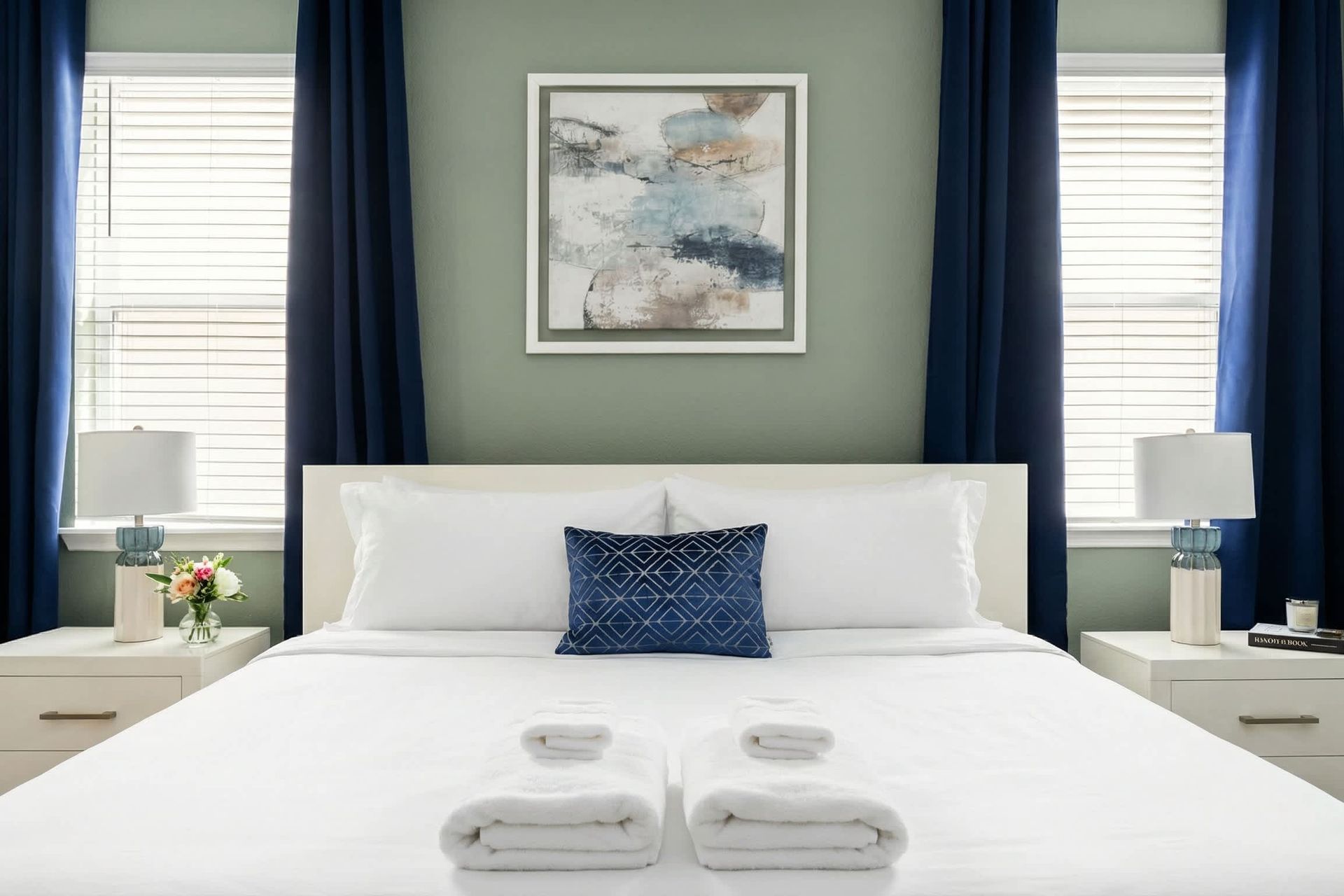 Chic modern bedroom with cozy bedding, elegant lighting, and serene ambiance.