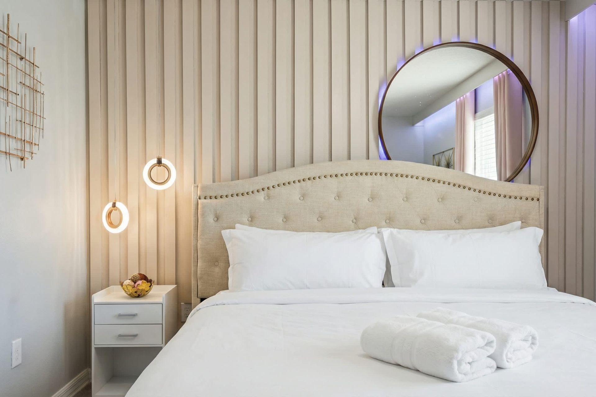 Romantic retreat with soft blush tones, modern lighting, and elegant décor touches.