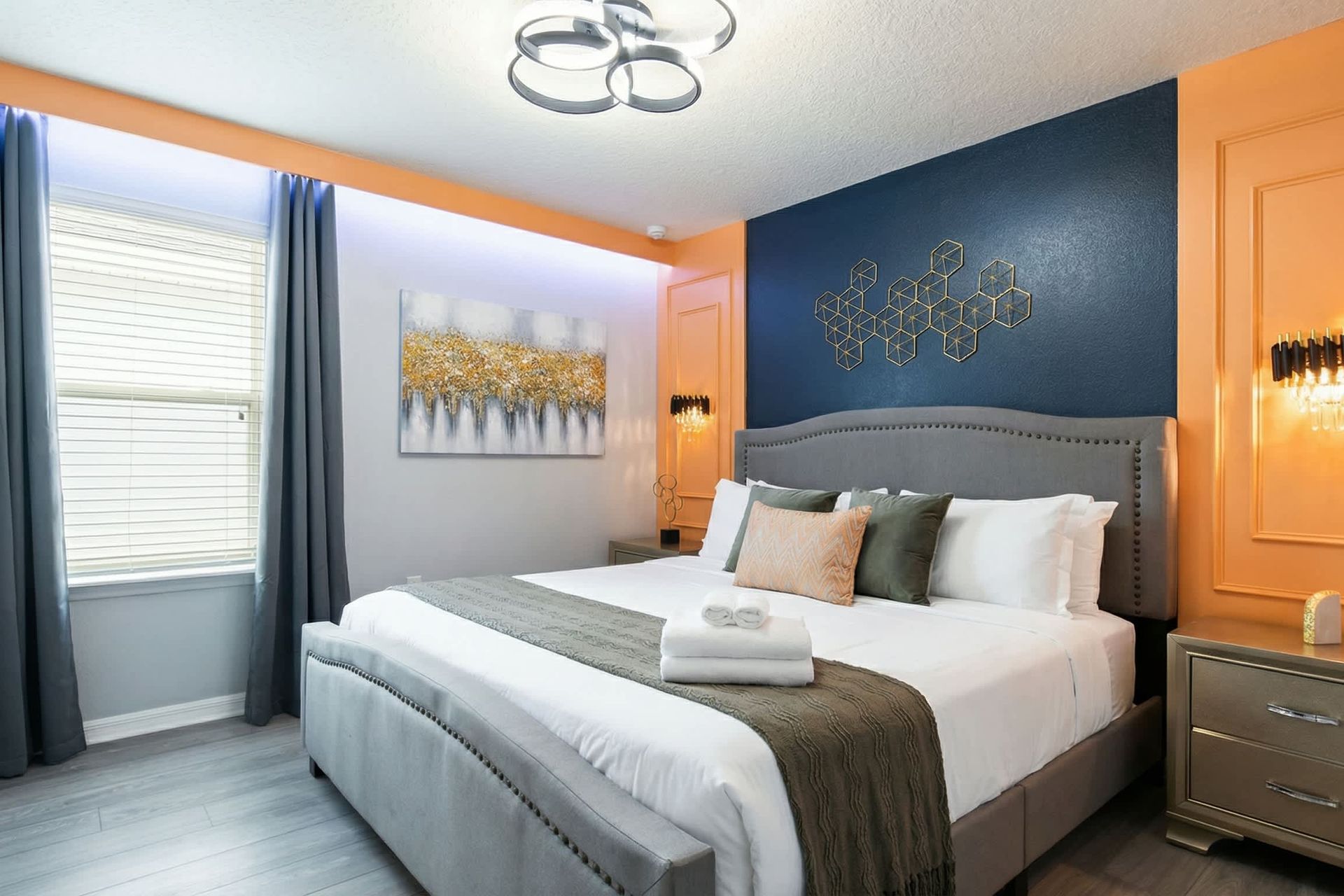 Stylish bedroom with bold accent walls, modern lighting, and luxe cozy bedding.