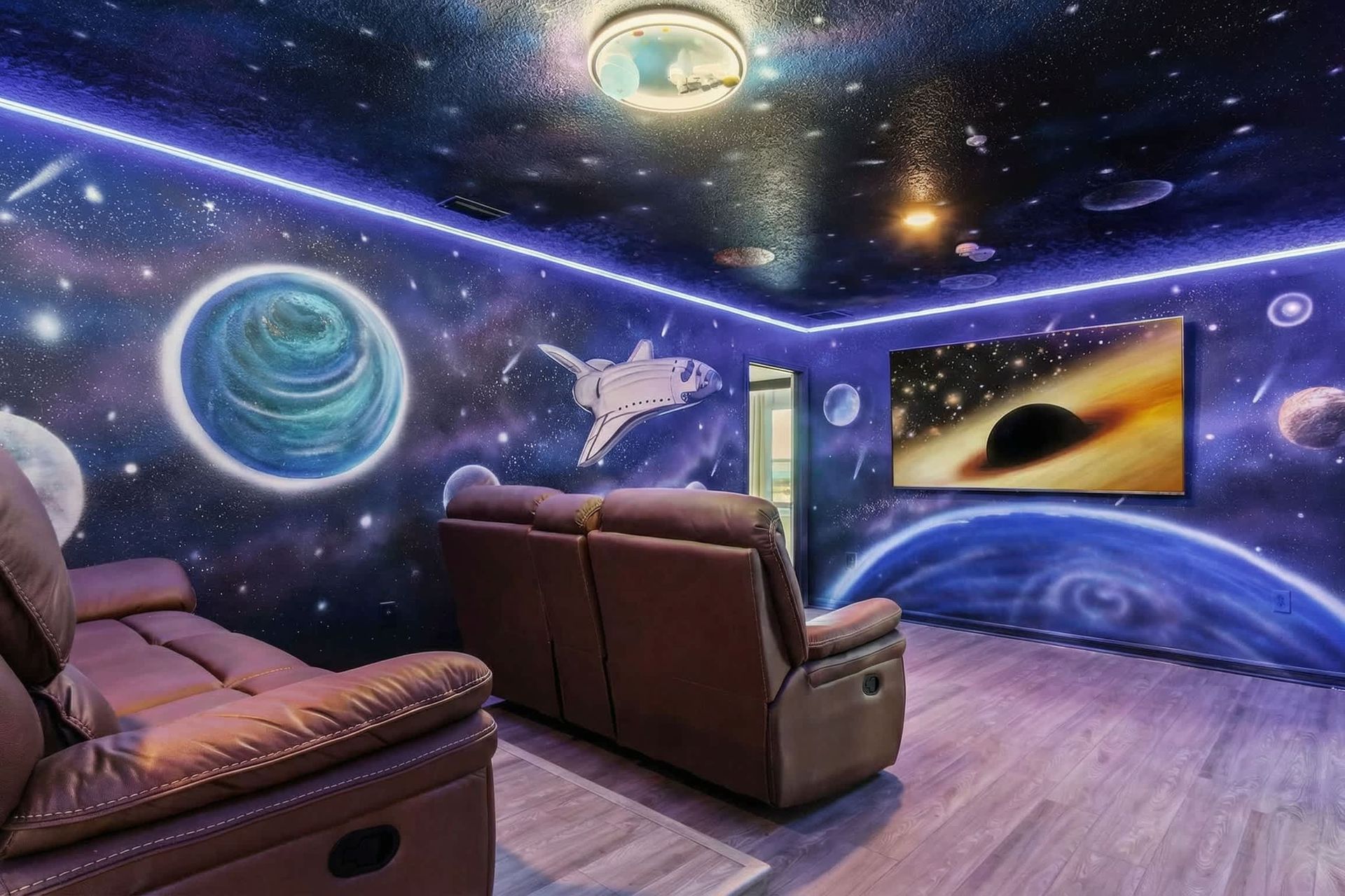 Immersive galaxy-themed theater with recliners, LED lighting, and epic vibes.