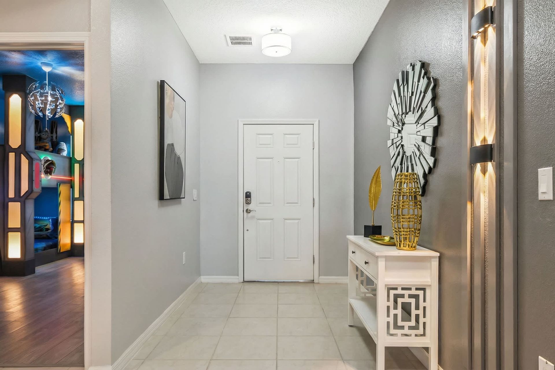 Stylish entryway with modern decor welcomes you to a fun and luxurious stay.