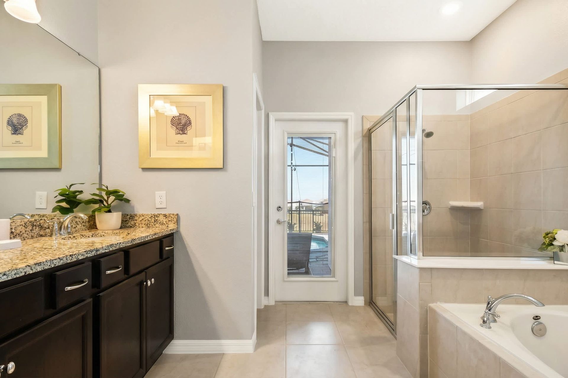 Elegant ensuite with soaking tub, walk-in shower, and private poolside access.