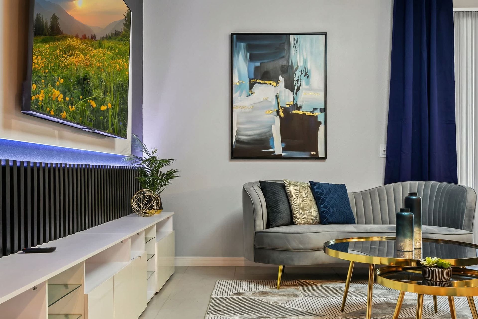 Stylish lounge with velvet seating, gold accents, and a sleek entertainment setup.