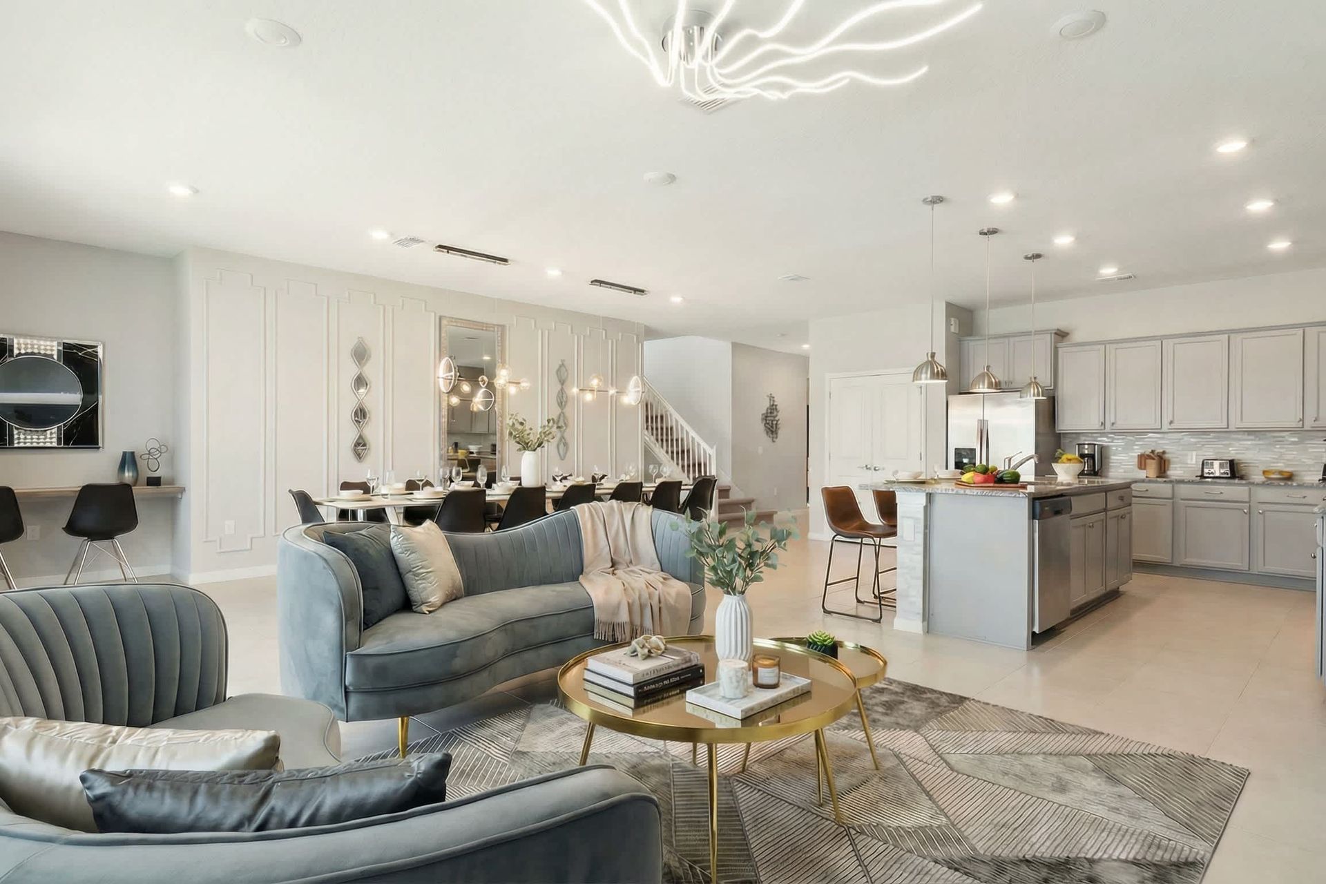 Spacious open-concept living with designer kitchen, luxe lounge, and dining area.