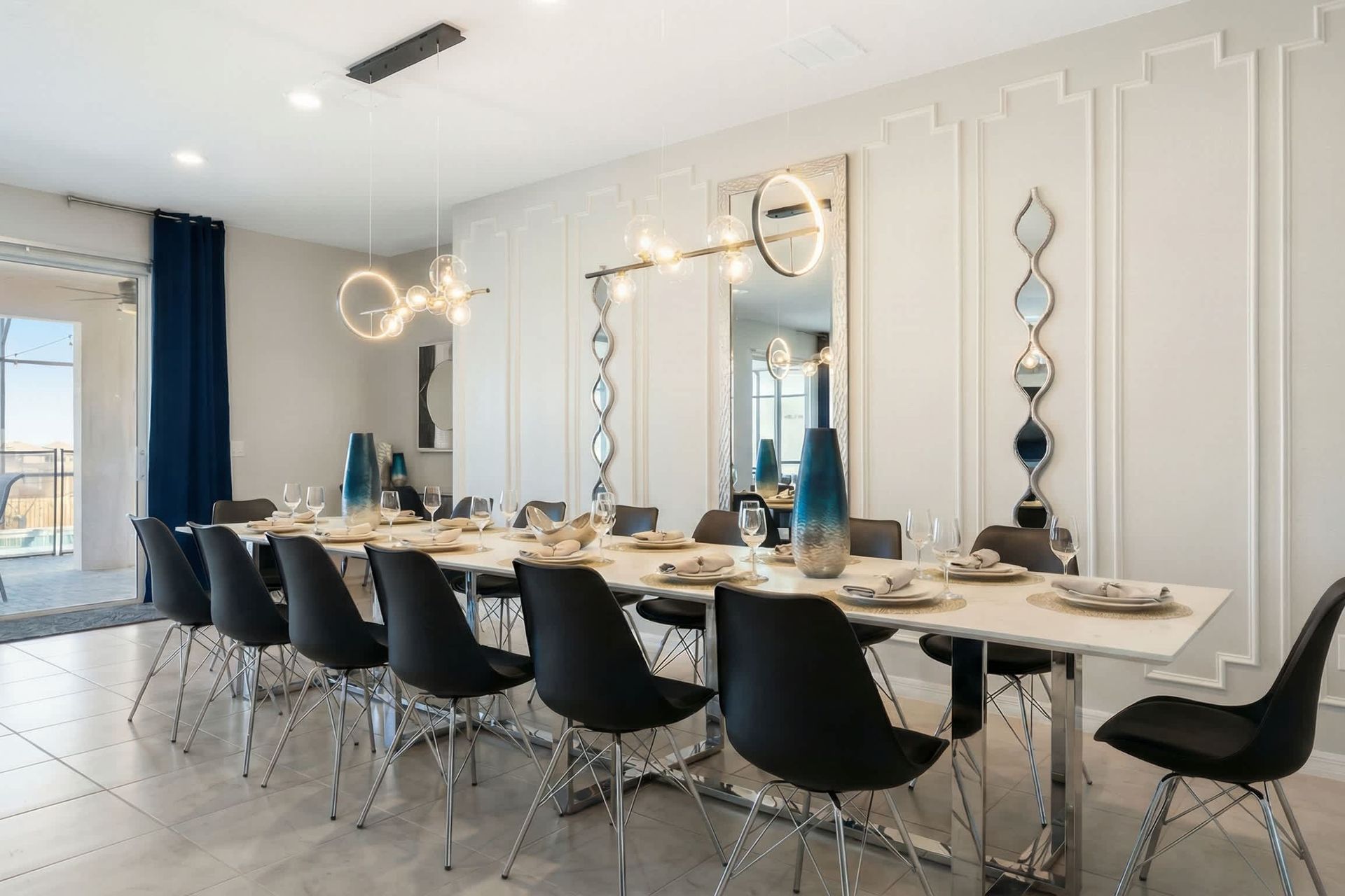 Elegant dining space with seating for 12, modern lighting, and pool views.