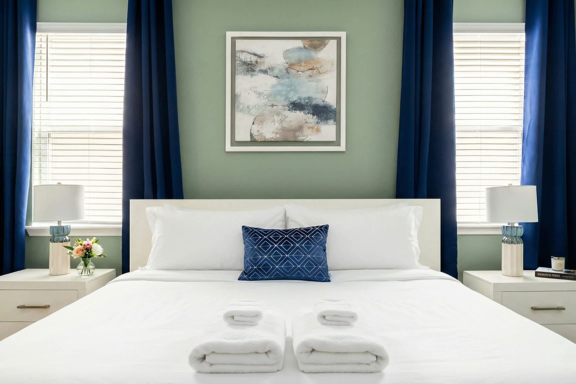 Chic modern bedroom with cozy bedding, elegant lighting, and serene ambiance.