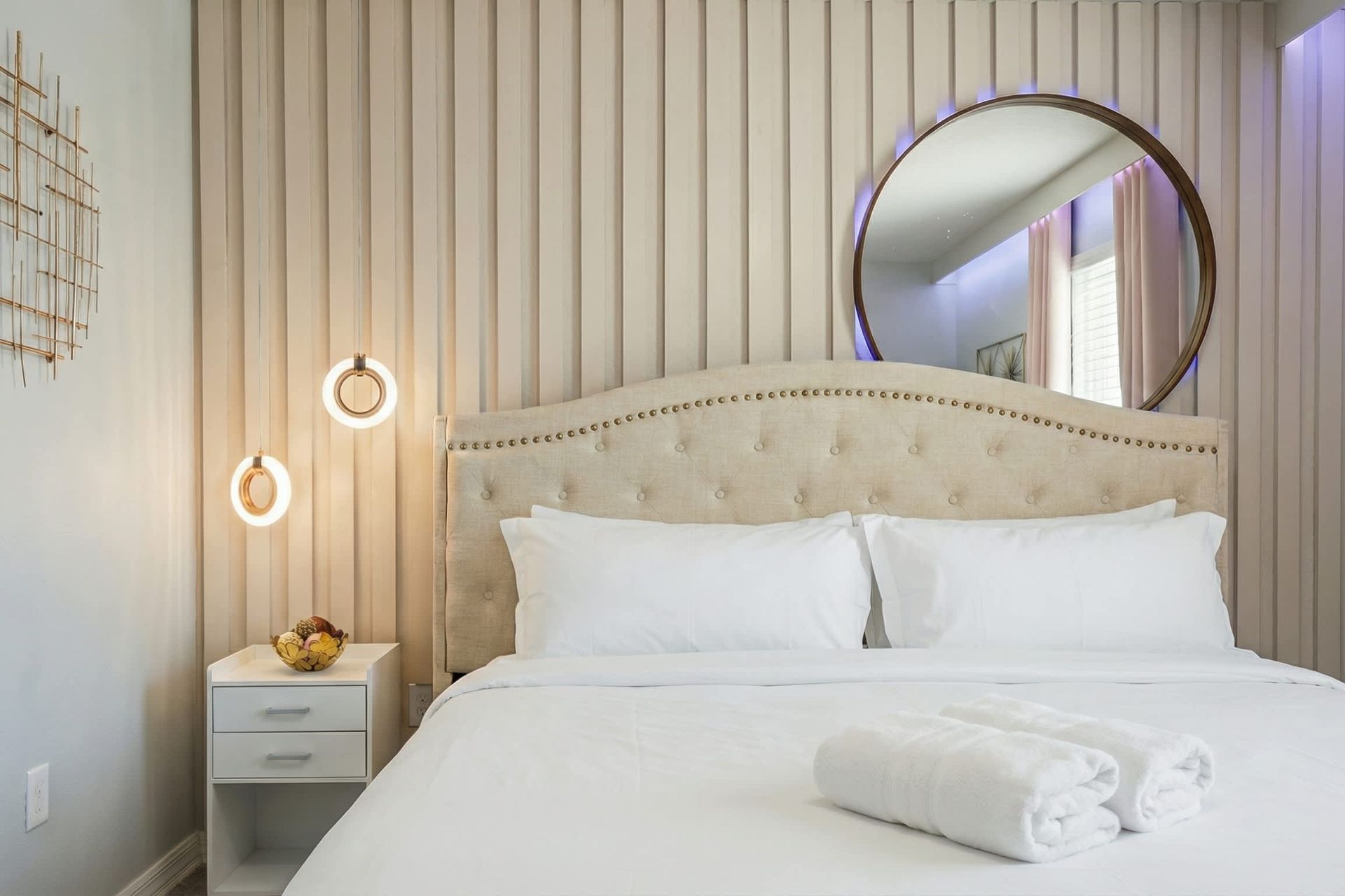 Romantic retreat with soft blush tones, modern lighting, and elegant décor touches.