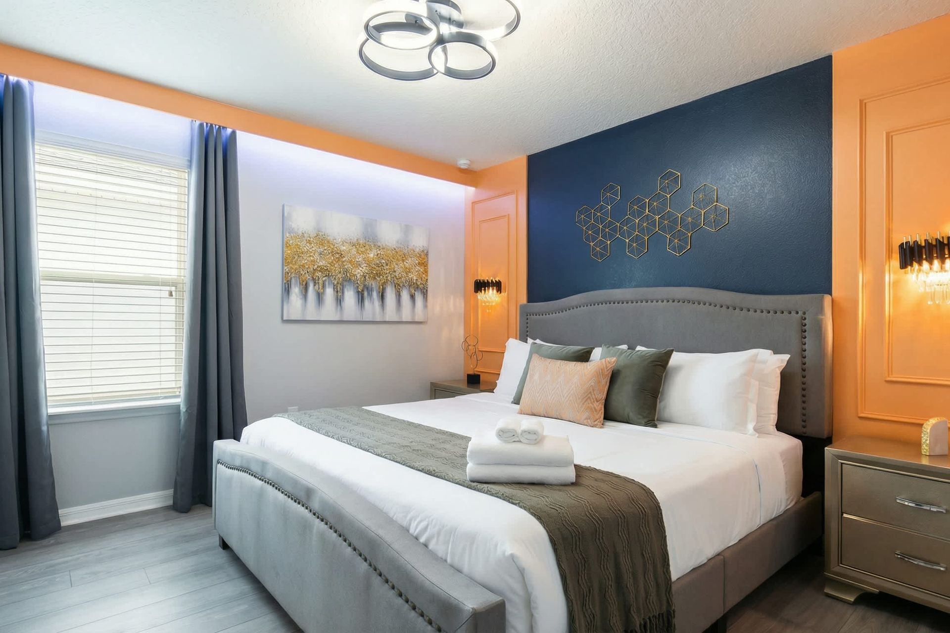 Stylish bedroom with bold accent walls, modern lighting, and luxe cozy bedding.