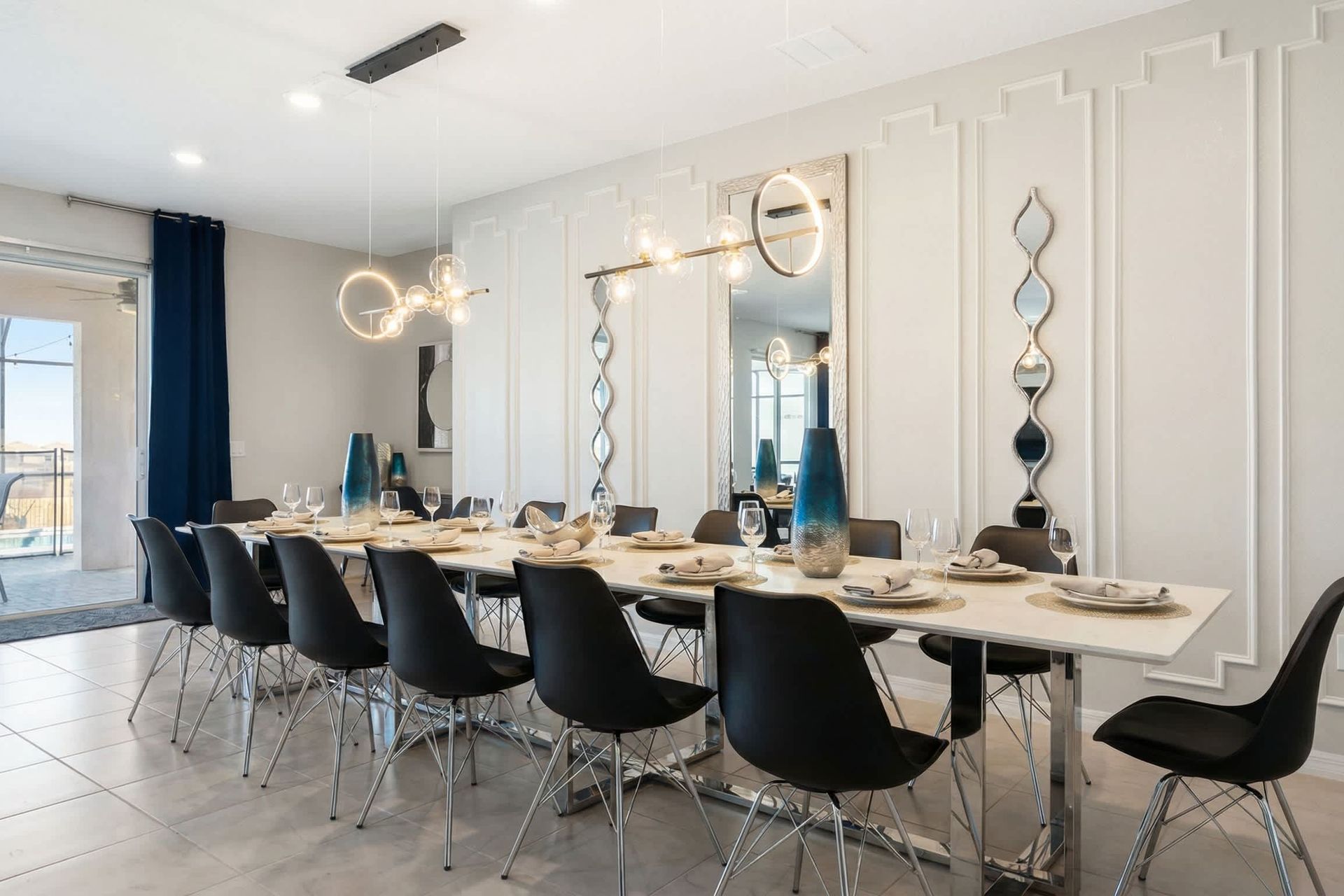 Elegant dining space with seating for 12, modern lighting, and pool views.